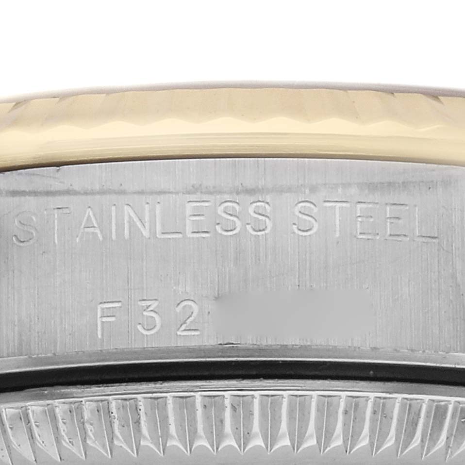 The image shows a close-up of the case back of a Rolex Oyster Perpetual 76193 Women
s Steel and Gold (two tone) Champagne Dial 76193 Women
s Steel and Gold (two tone) Champagne Dial, highlighting the "STAINLESS STEEL" engraving and part of the bezel.