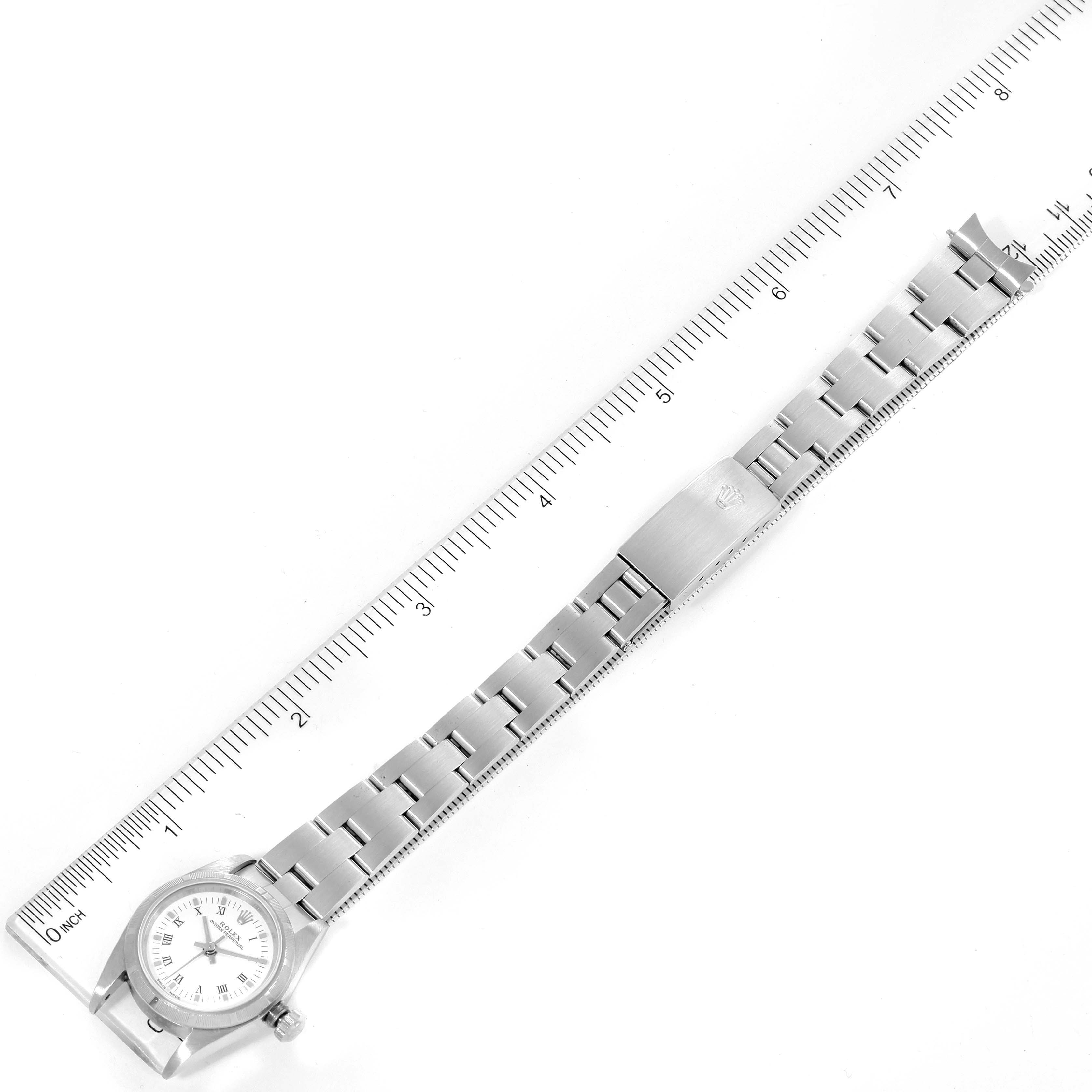 The image shows an overhead view of a Rolex Oyster Perpetual 76030 Women's Stainless Steel White Dial 76030 Women's Stainless Steel White Dial watch with a ruler beside it for measurement.
