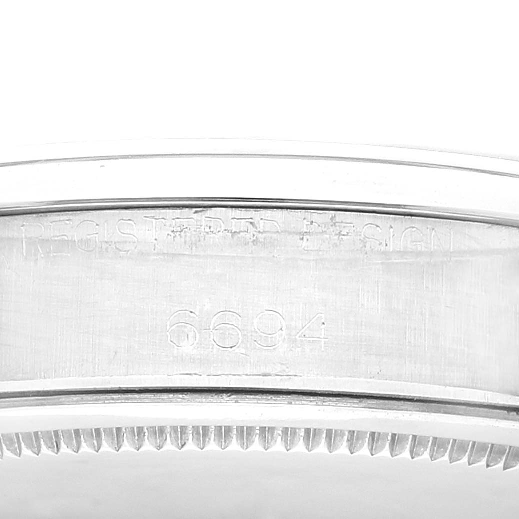 This image shows a close-up view of the side of a Vintage Collection Rolex watch, displaying the model number 6694.