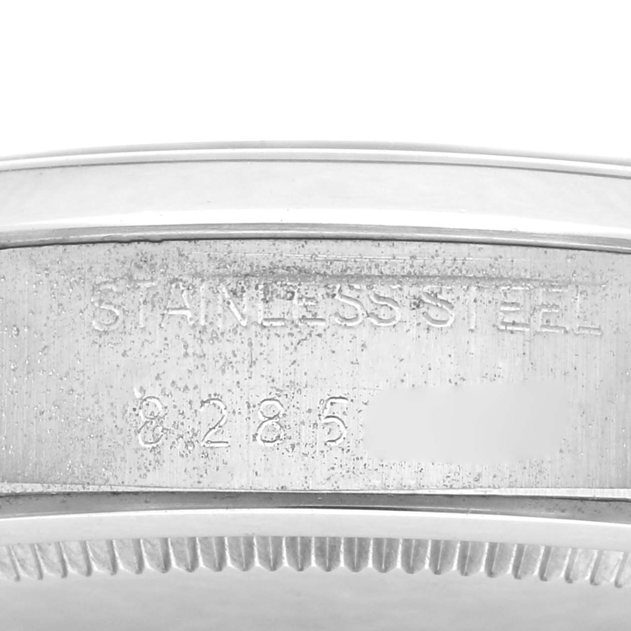 The image shows a close-up of the side of a Rolex Vintage Collection 6694 Men
s Stainless Steel Silver Dial 6694 Men
s Stainless Steel Silver Dial watch, highlighting the engraved "STAINLESS STEEL" marking.