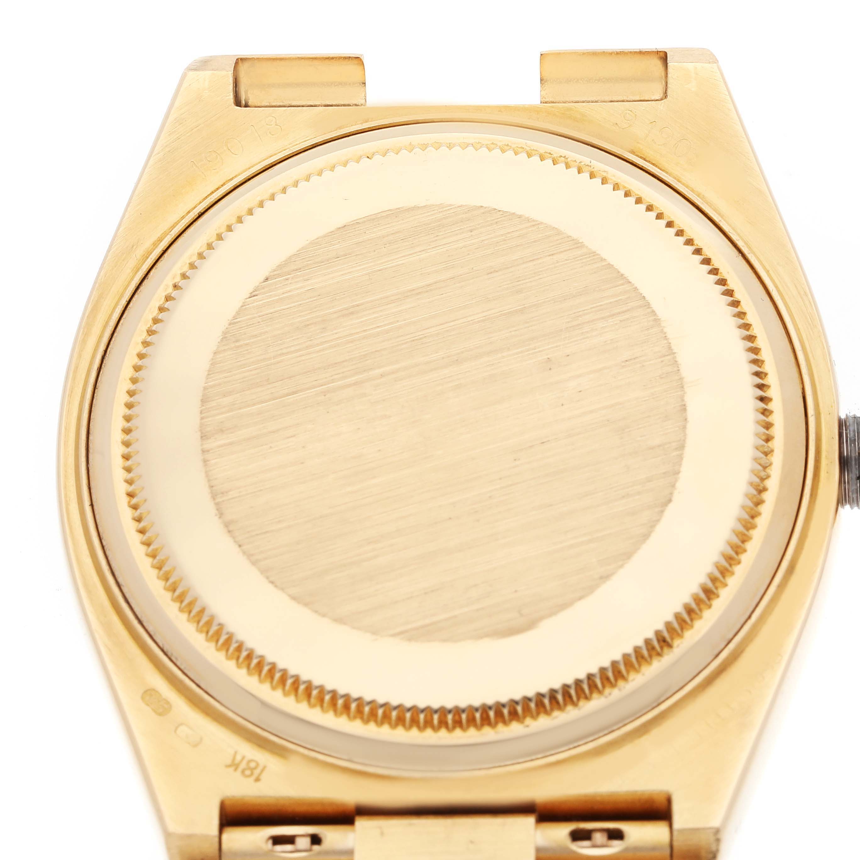 The image shows the case back of a Rolex Oysterquartz 19018 Men's Yellow Gold Champagne Dial 19018 Men's Yellow Gold Champagne Dial watch from a rear view angle.