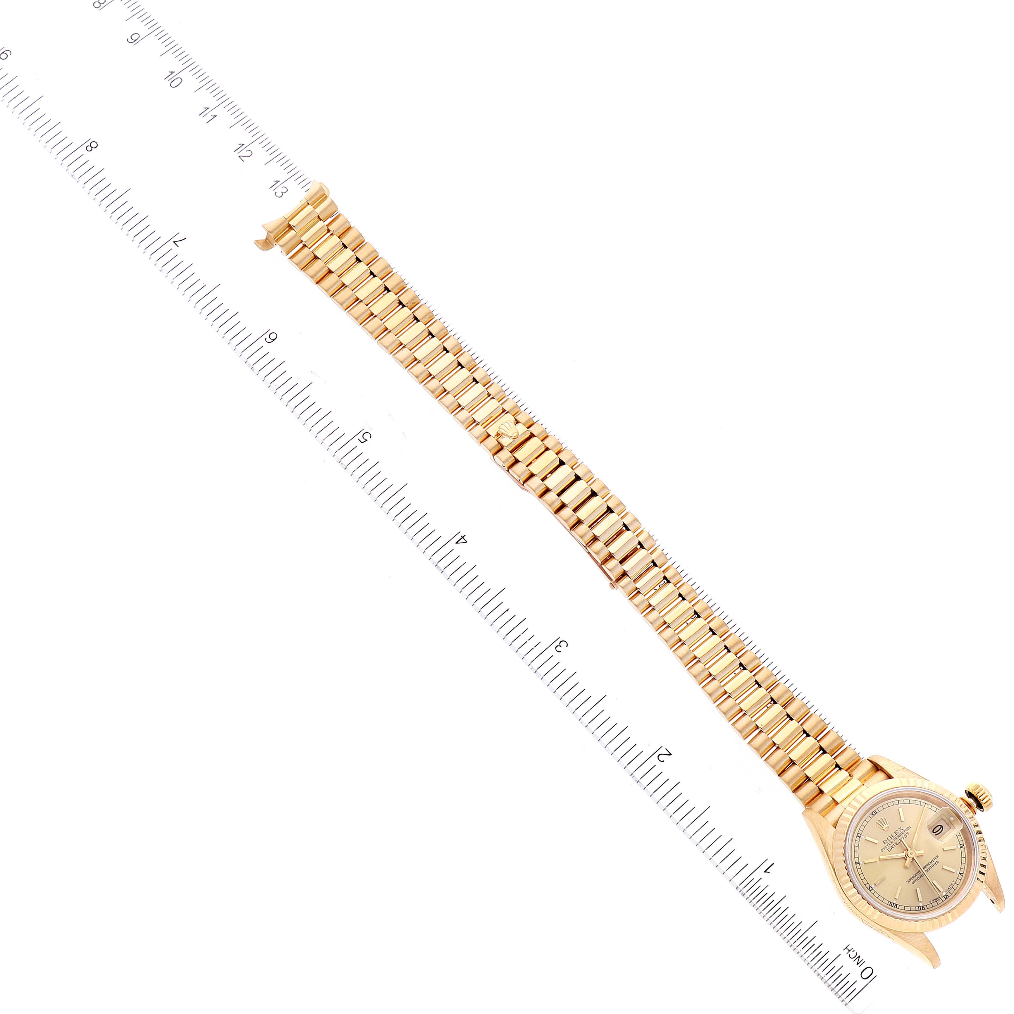 The image shows a Rolex President 69178 Women
s Yellow Gold Champagne Dial 69178 Women
s Yellow Gold Champagne Dial model watch, captured from a top-down angle, displaying its full golden bracelet and face.