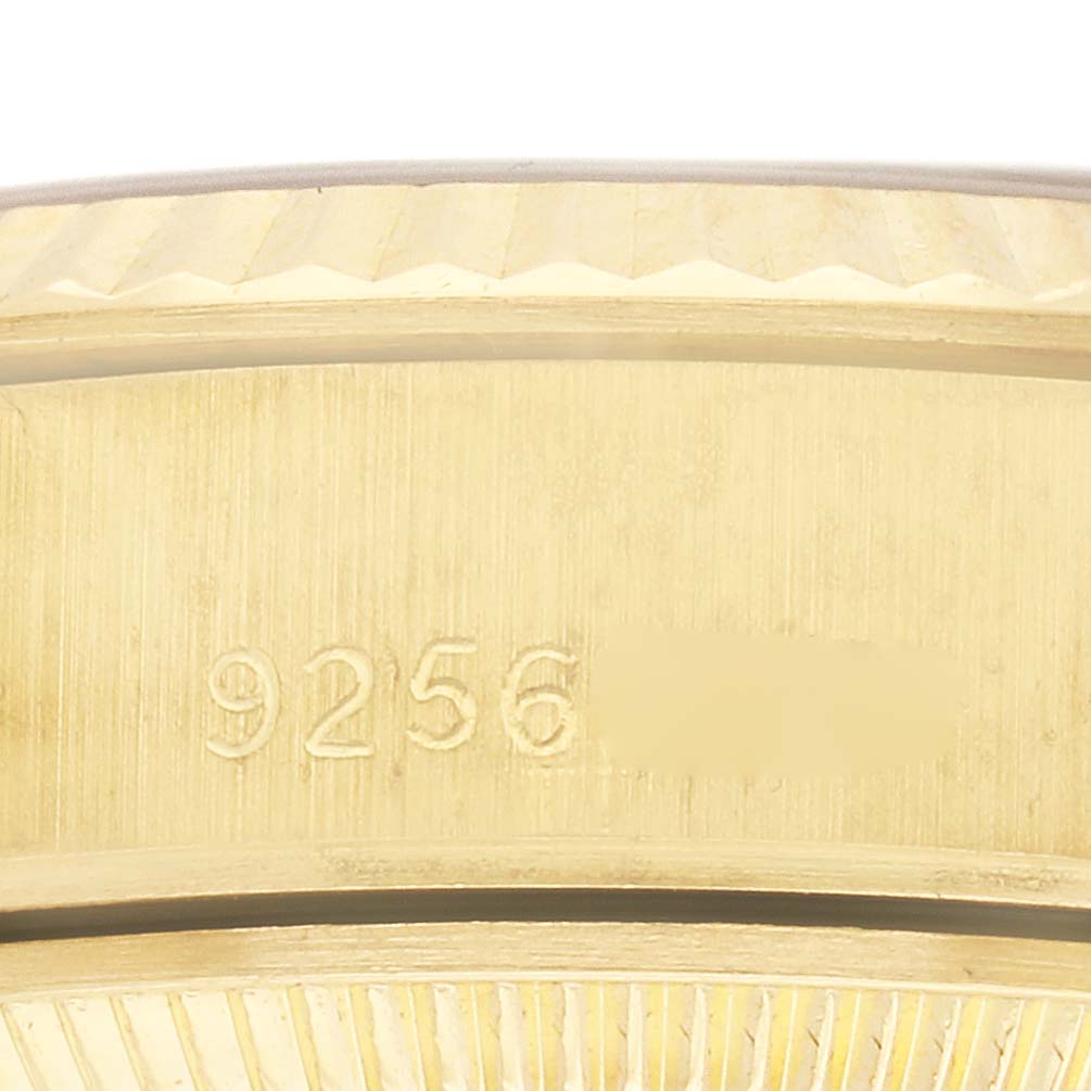 The image shows a close-up of the side of a Rolex President 69178 Women
s Yellow Gold Champagne Dial 69178 Women
s Yellow Gold Champagne Dial watch case with engraved numbers.