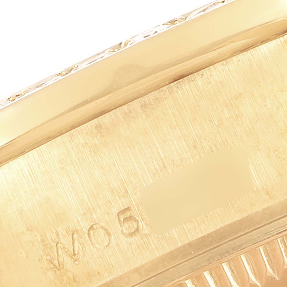 This is a close-up angle of the case side and part of the bezel of a Rolex President 69158 Women's Yellow Gold Black Dial 69158 Women's Yellow Gold Black Dial model watch.
