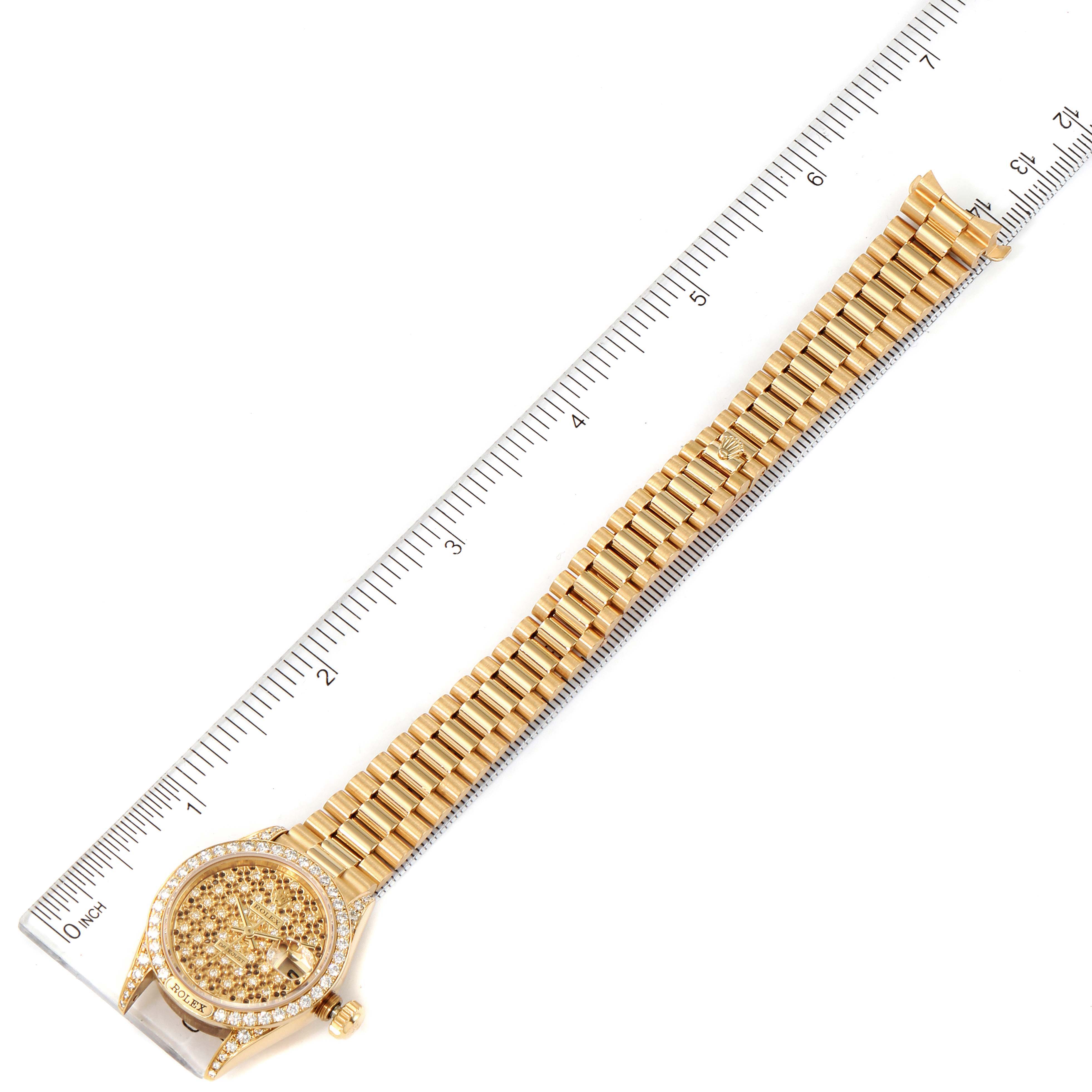 The image shows a top-down view of a gold Rolex President 69158 Women's Yellow Gold Champagne Dial 69158 Women's Yellow Gold Champagne Dial model watch with a ruler for size reference.