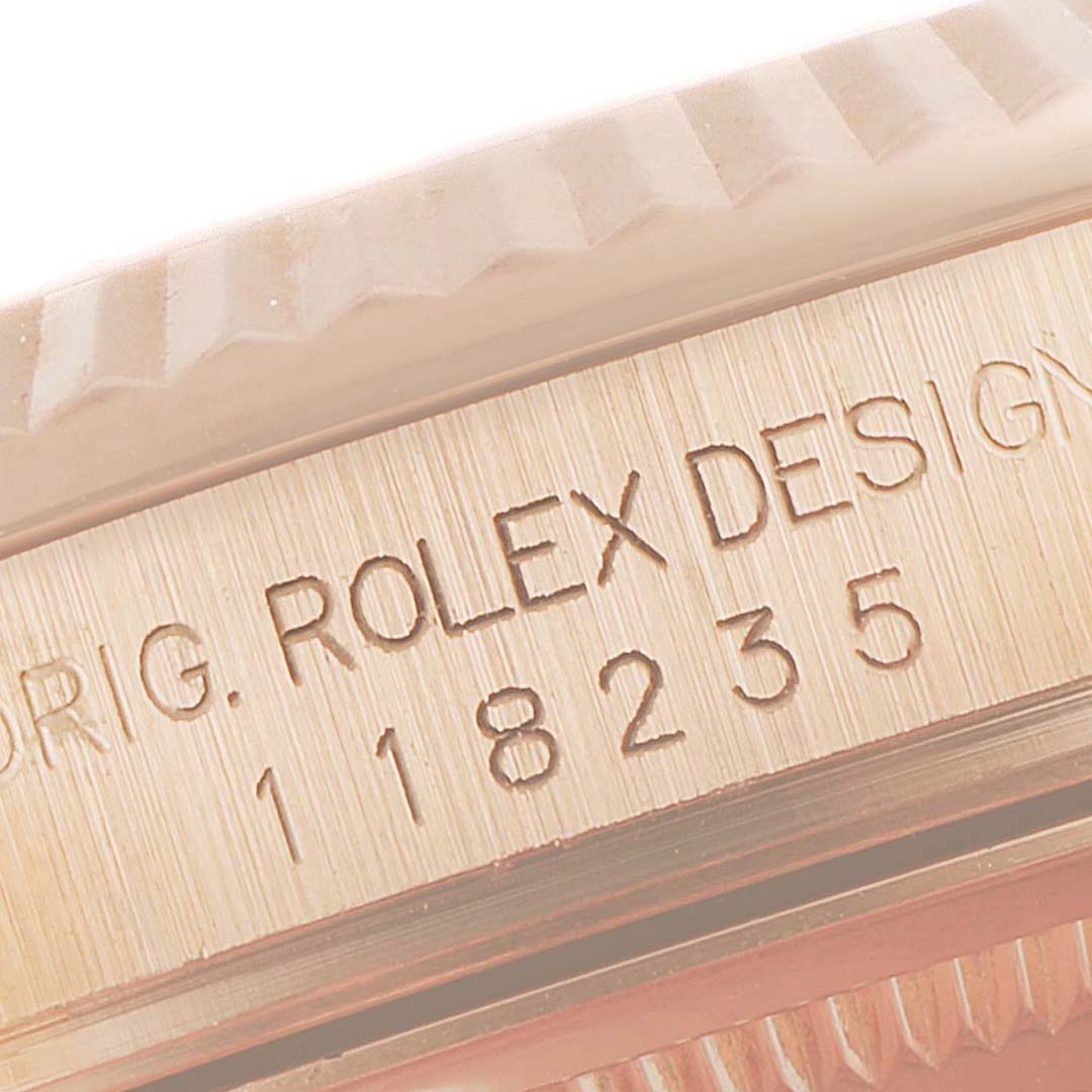 This close-up angle shows the serial number and design engraving on the side of a Rolex President 118235 Men's Rose Gold Pink Dial 118235 Men's Rose Gold Pink Dial model watch.