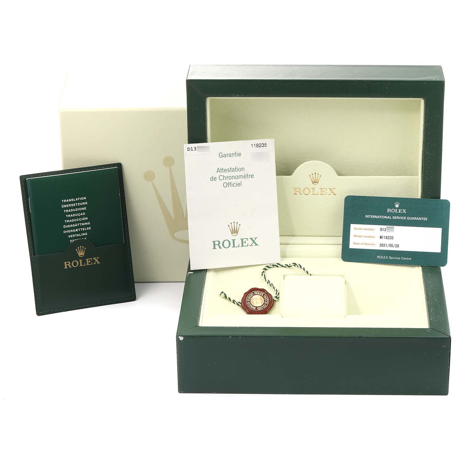 This image shows the packaging, warranty card, booklet, and tags for a Rolex President 118235 Men's Rose Gold Pink Dial 118235 Men's Rose Gold Pink Dial model watch.