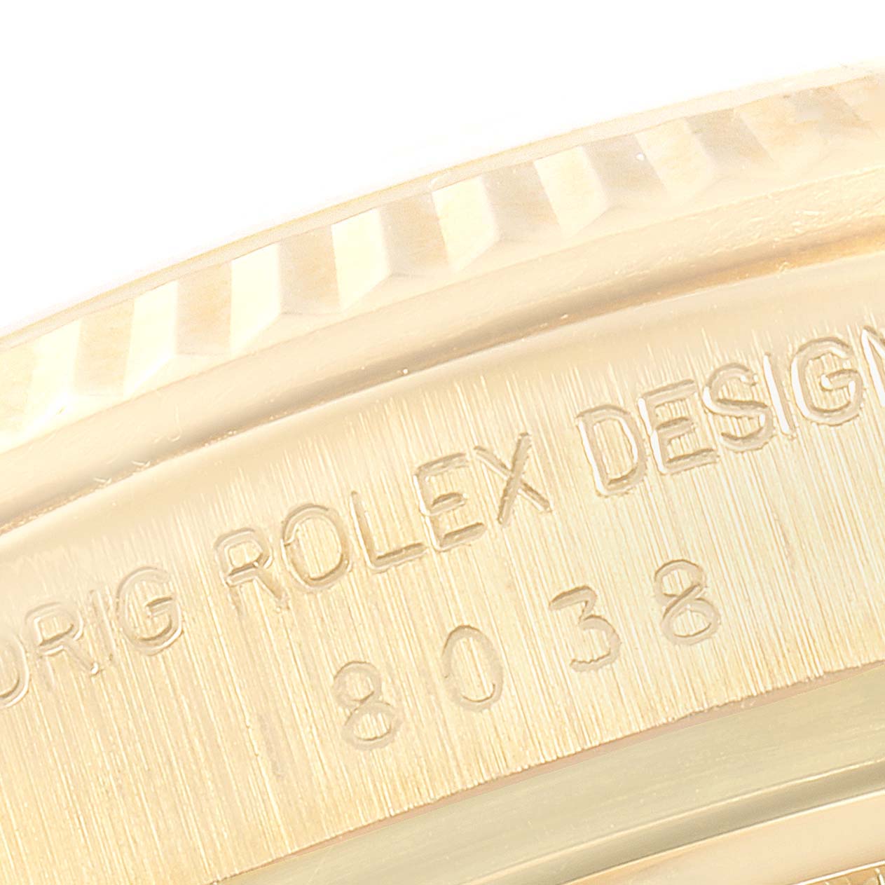 The image shows a close-up of the fluted bezel and design engraving on the side of a Rolex President 18038 Men's Yellow Gold Champagne Dial 18038 Men's Yellow Gold Champagne Dial model watch.