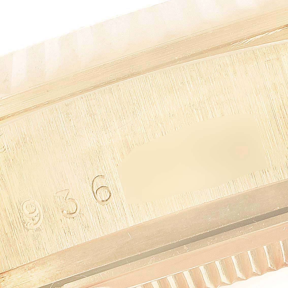 This image shows a close-up of the case and serial number of a Rolex President 18038 Men's Yellow Gold Champagne Dial 18038 Men's Yellow Gold Champagne Dial model watch.
