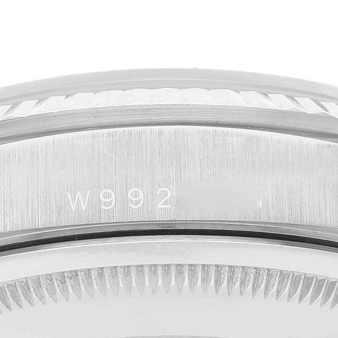 The image shows a close-up of the serial number on the bezel area of a Rolex President 18239 Men's White Gold Silver Dial 18239 Men's White Gold Silver Dial watch.