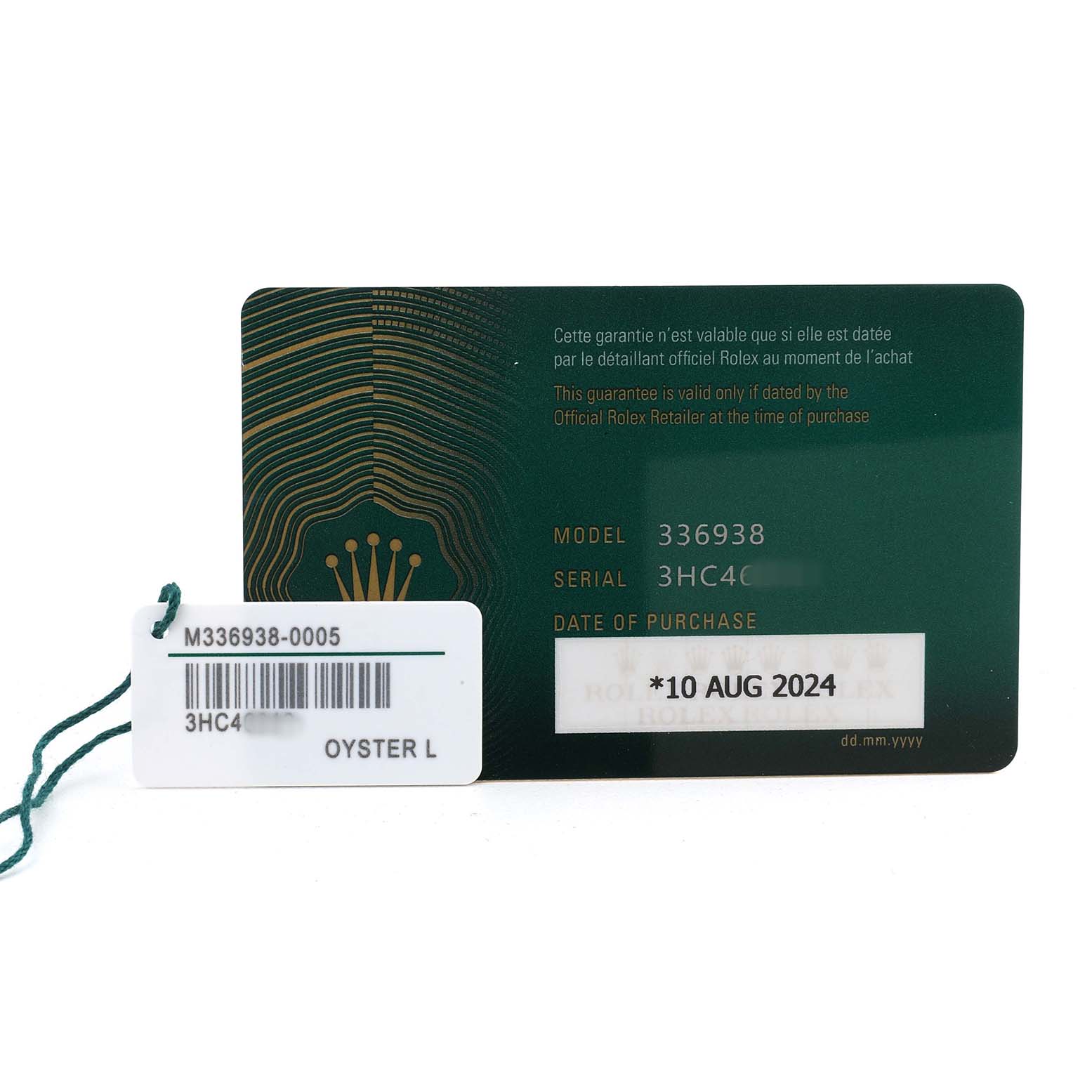 The image shows a warranty card and tag for the Rolex Sky-Dweller 336938 Men's Yellow Gold Black Dial, detailing model and serial numbers.