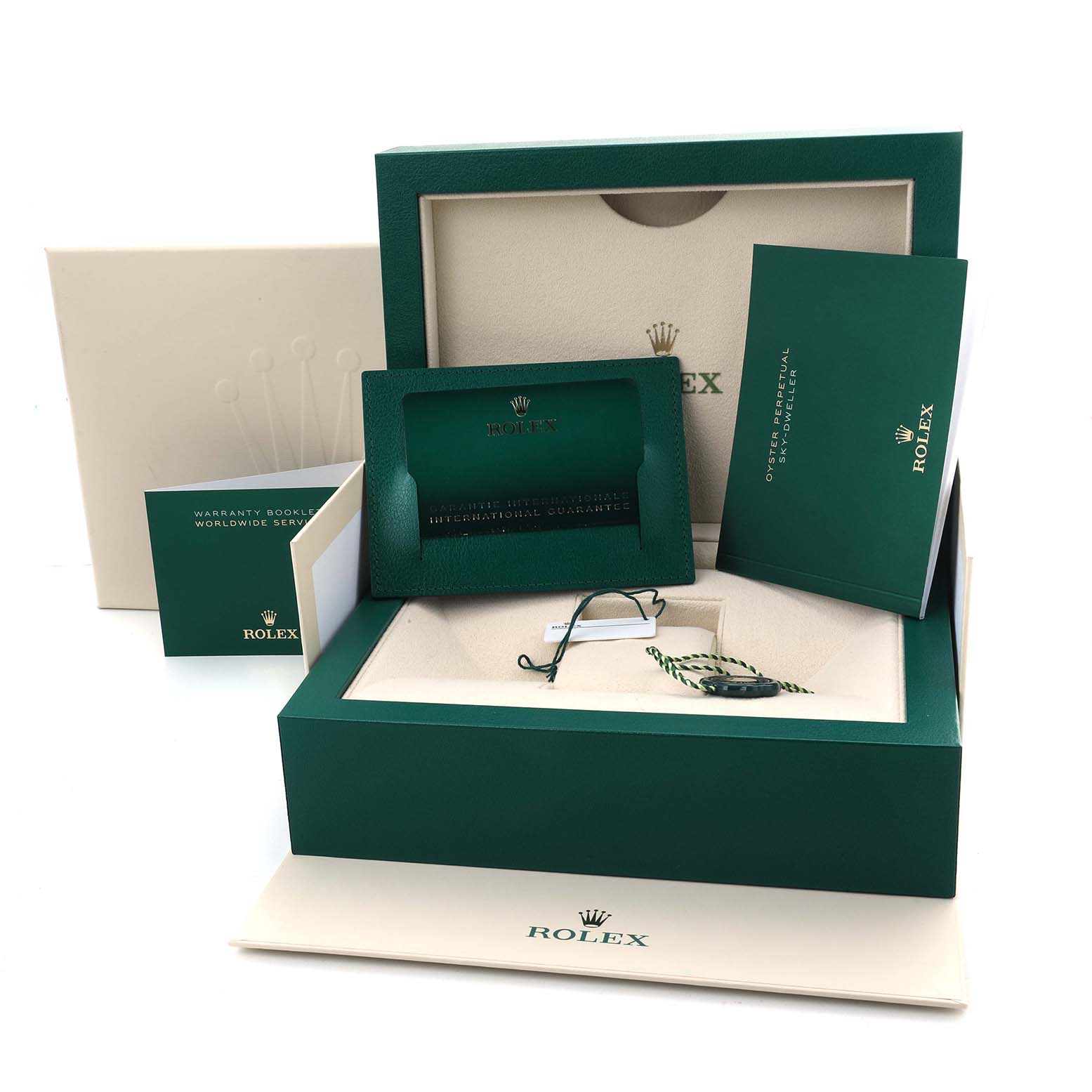 The image shows the packaging and accessories for a Rolex Sky-Dweller 336938 Men's Yellow Gold Black Dial, including the box, papers, and tags.