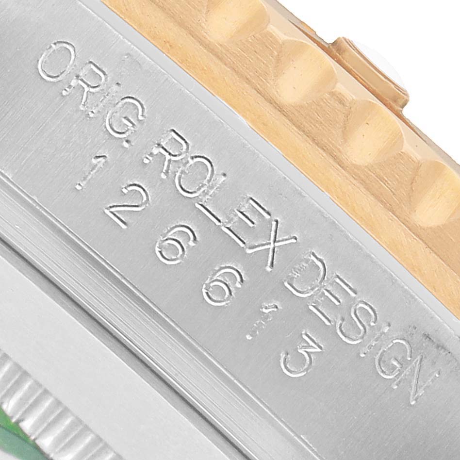 The image shows a close-up of the side engraving on a Rolex Submariner M126613LN-0002 Men's Steel and Gold (two tone) Black Dial, displaying the model number and "ORG. ROLEX DESIGN."