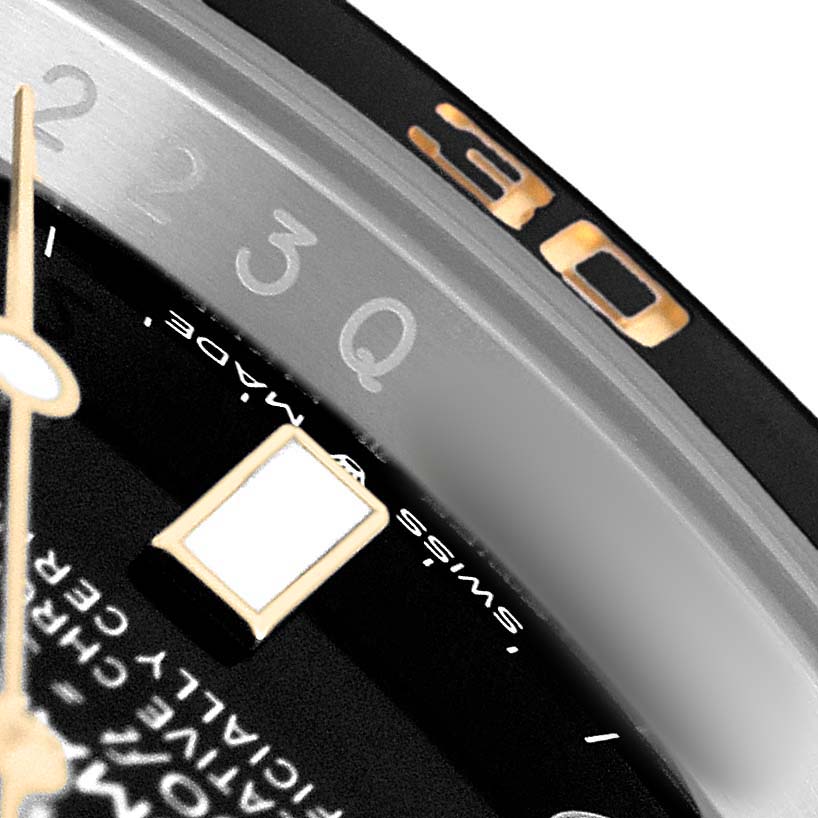 The image shows a close-up of the Rolex Submariner M126613LN-0002 Men's Steel and Gold (two tone) Black Dial watch's dial, bezel, and part of the hands.