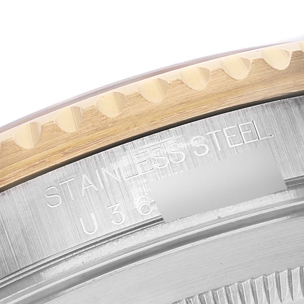 This close-up image shows the outer rim and stainless steel engraving of a Rolex Submariner 16613 Men's Steel and Gold (two tone) Blue Dial 16613 Men's Steel and Gold (two tone) Blue Dial watch.
