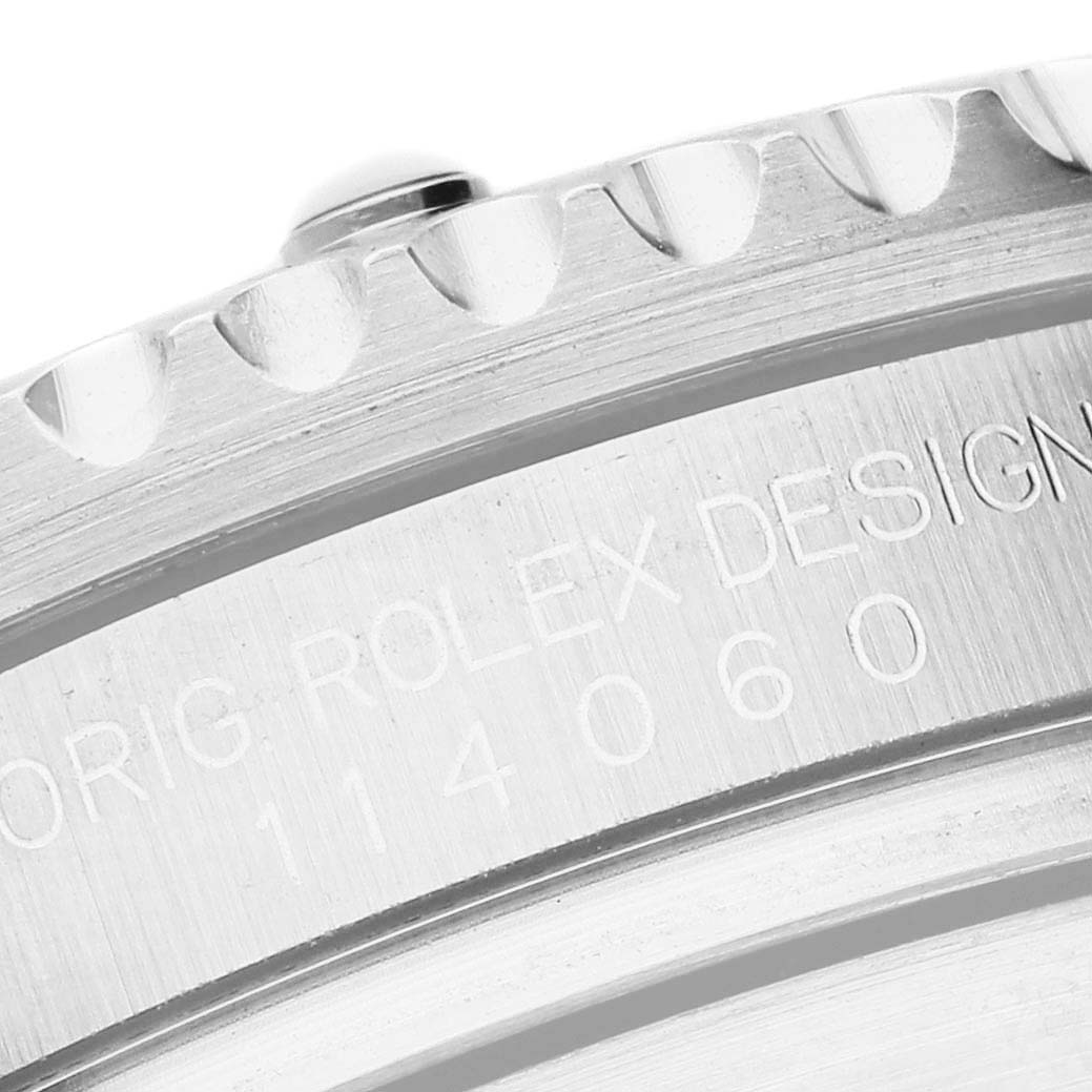 The image shows a close-up of the edge and bezel teeth of a Rolex Submariner 114060 Men's Stainless Steel Black Dial watch, with part of the case visible.