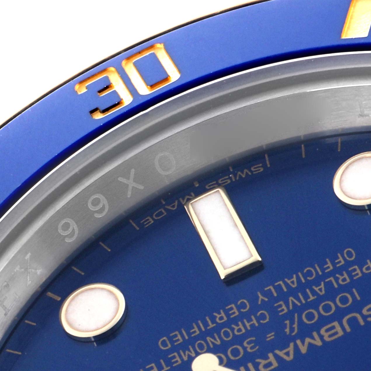 The image shows a close-up of the Rolex Submariner 116613 Men
s Steel and Gold (two tone) Blue Dial 116613 Men
s Steel and Gold (two tone) Blue Dial
s blue bezel and part of the dial, highlighting the 30-minute mark and dial text.