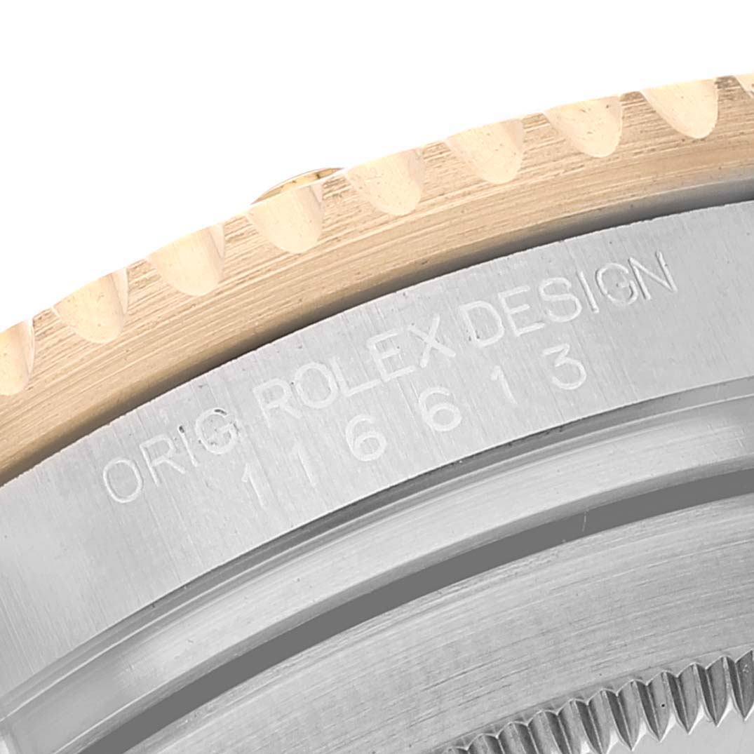 The image shows a close-up of the bezel and case sides of a Rolex Submariner 116613 Men
s Steel and Gold (two tone) Blue Dial 116613 Men
s Steel and Gold (two tone) Blue Dial watch, revealing its engraved model number.