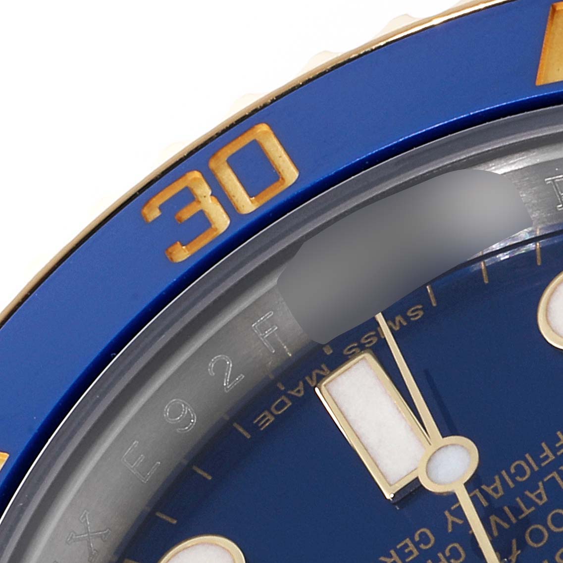 This image shows a close-up of the bezel and part of the dial of a Rolex Submariner 116613 Men
s Steel and Gold (two tone) Blue Dial 116613 Men
s Steel and Gold (two tone) Blue Dial watch.