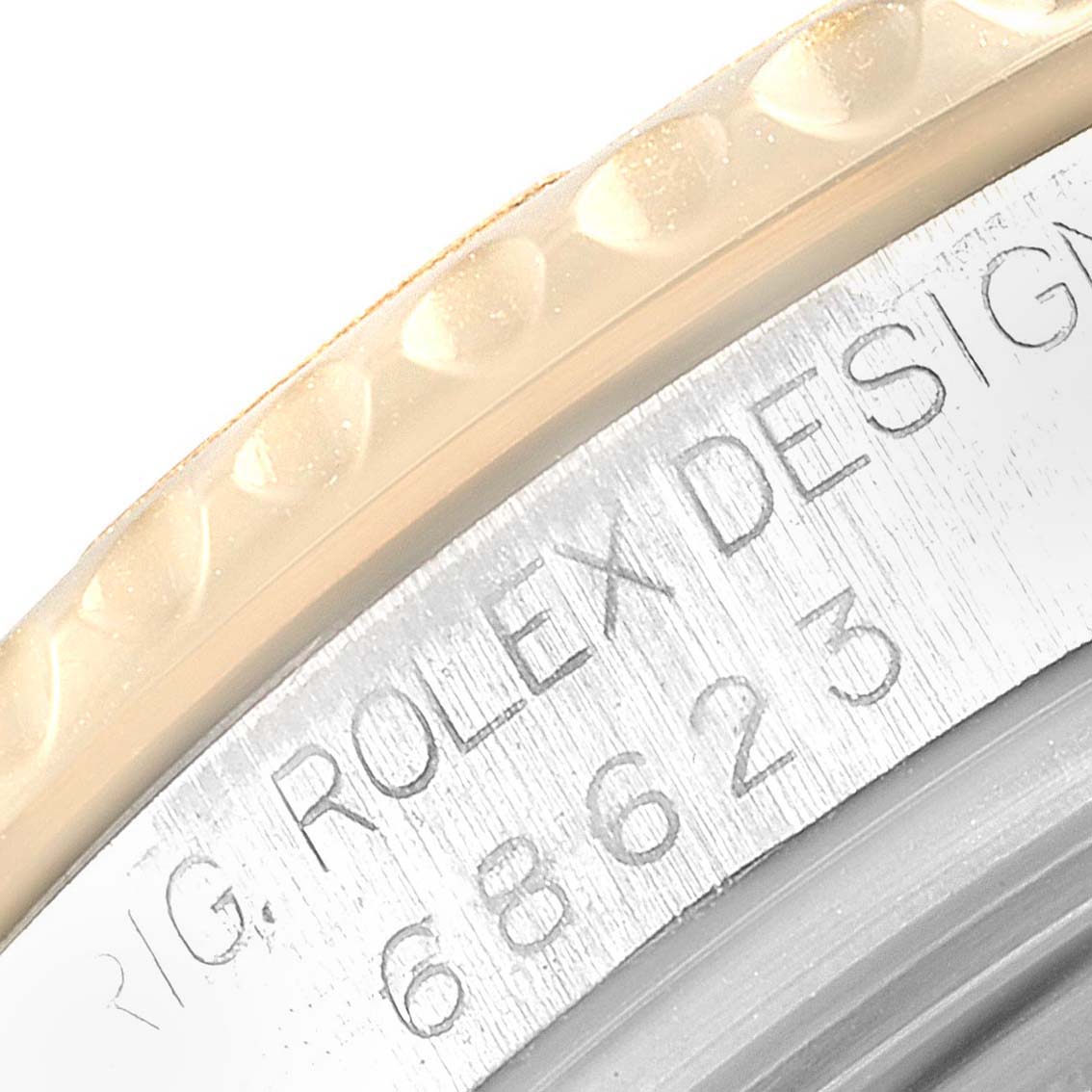 This close-up shows the engraved model number and part of the bezel of the Rolex Yacht-Master 68623 Men
s Steel and Gold (two tone) White Dial 68623 Men
s Steel and Gold (two tone) White Dial watch.