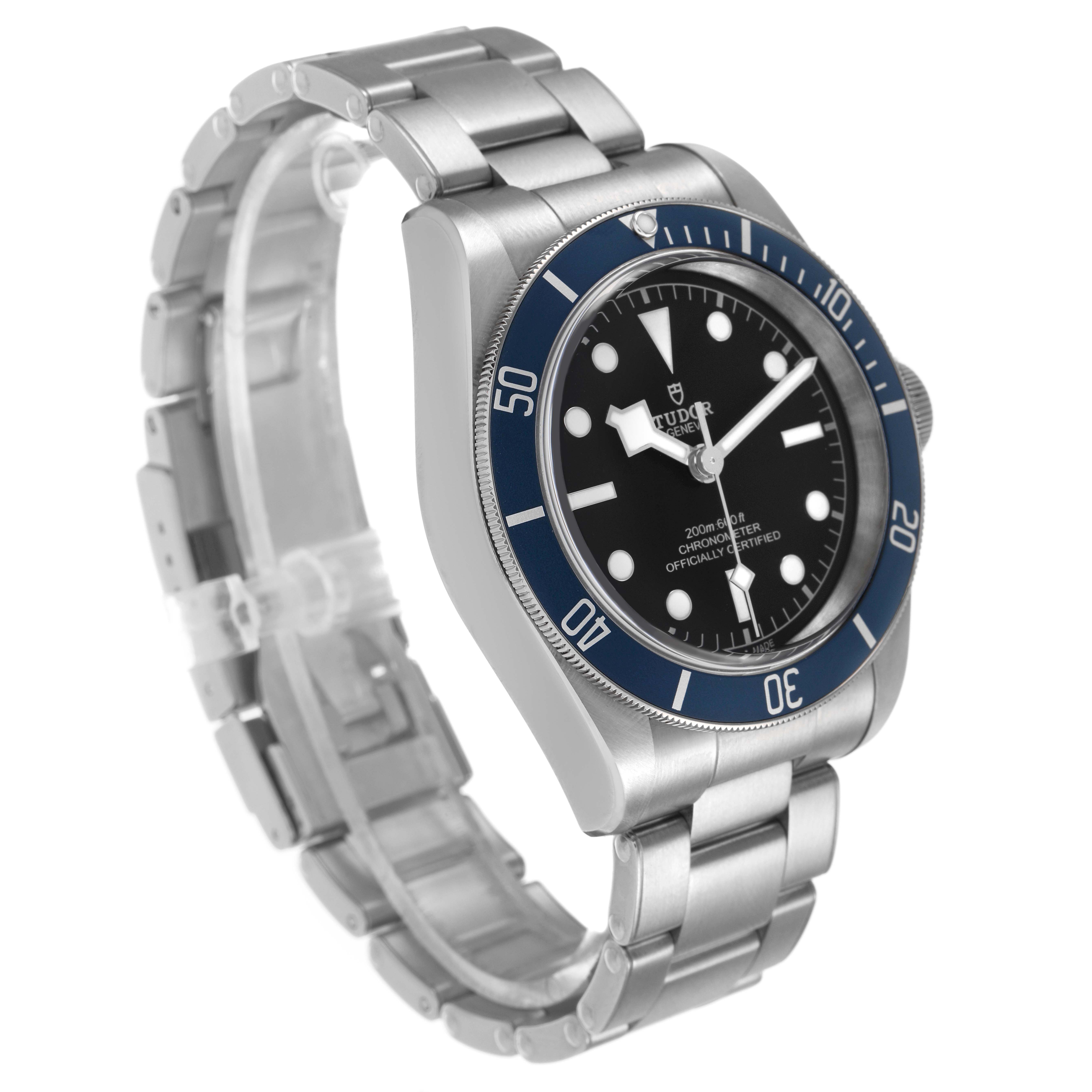 The Tudor Heritage Black Bay 79230B Men's Stainless Steel Black Dial watch is shown at a three-quarter angle highlighting the face, bezel, and bracelet.