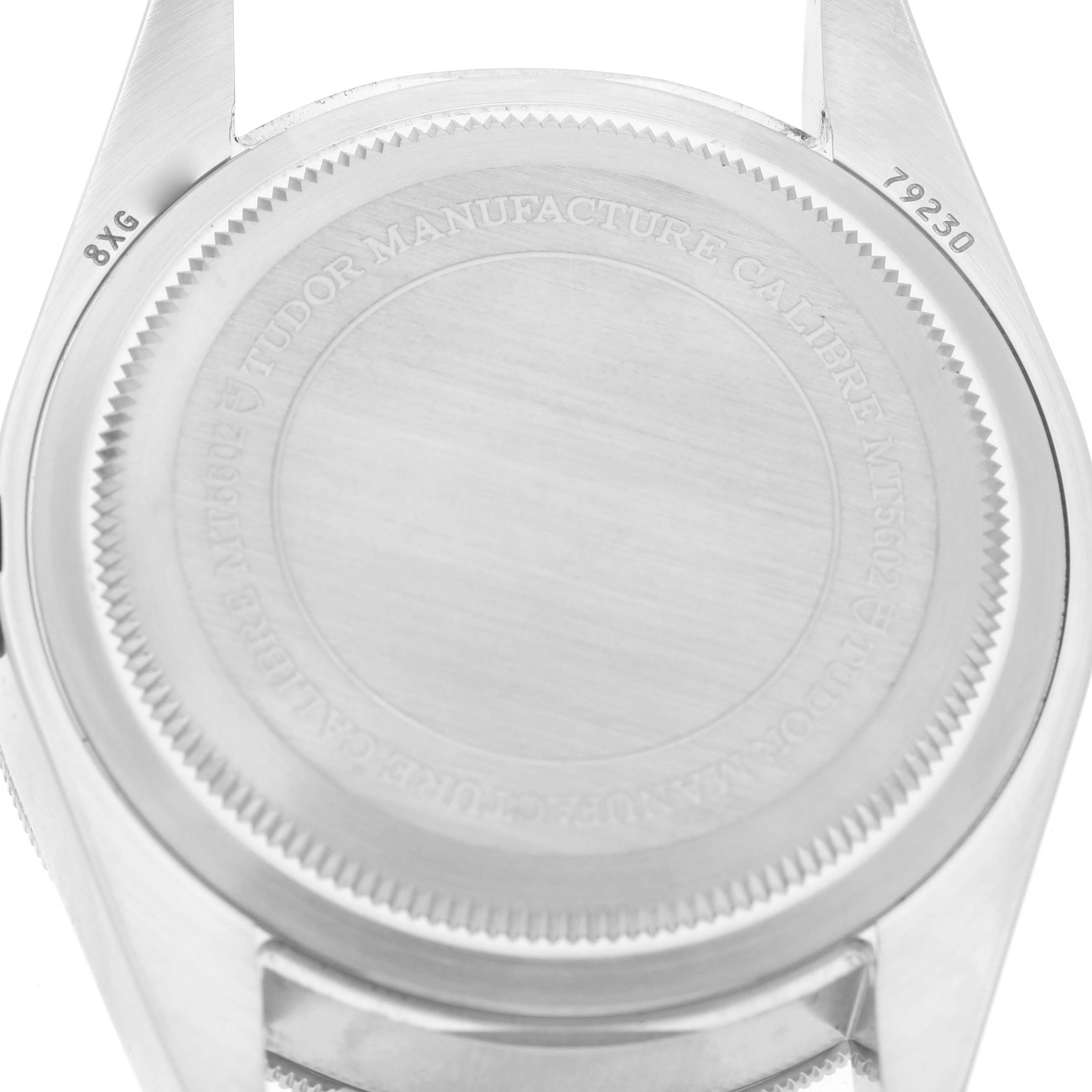 The image shows the back case of a Tudor Heritage Black Bay 79230B Men's Stainless Steel Black Dial watch, focusing on the caseback engravings.