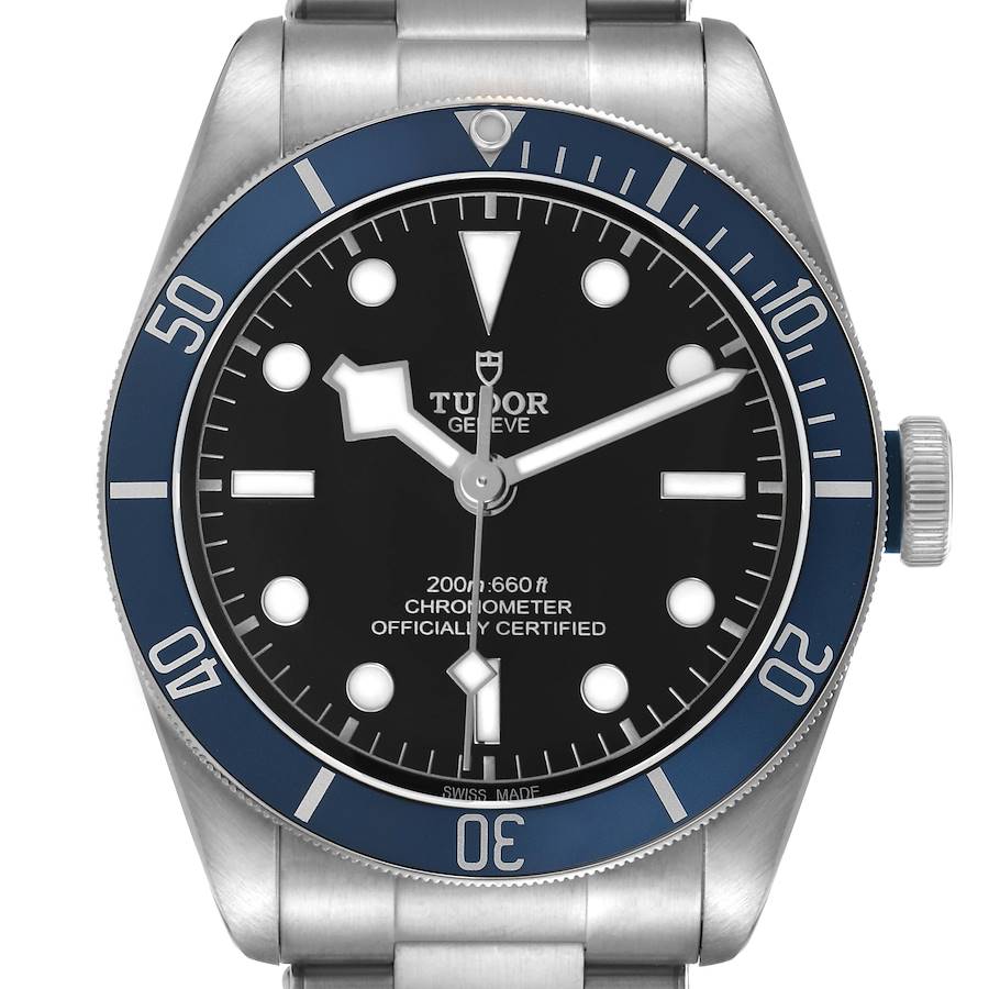 The Tudor Heritage Black Bay 79230B Men's Stainless Steel Black Dial watch is shown from a front angle, displaying the dial, bezel, and part of the bracelet.