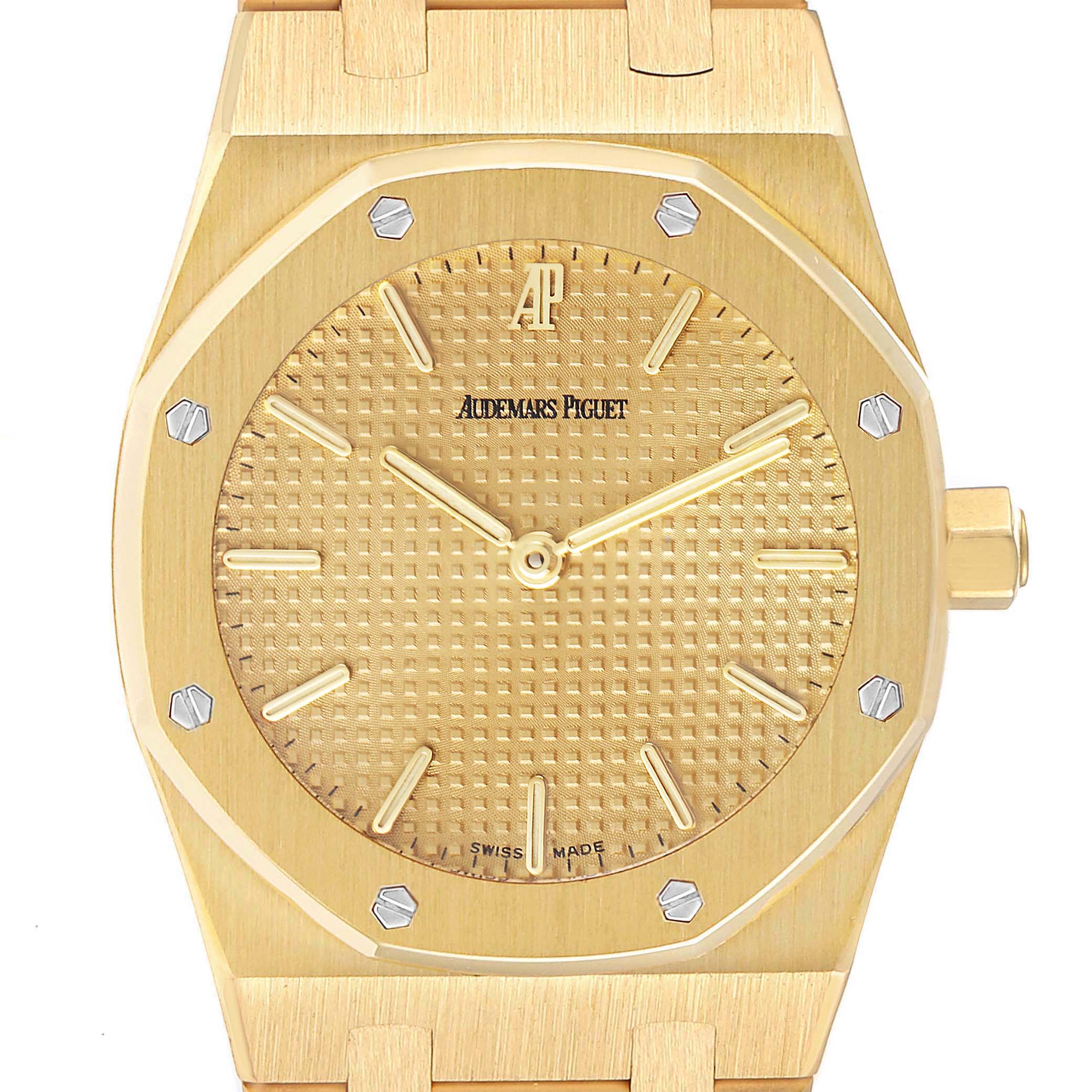 This image shows the face and crown of the Audemars Piguet Royal Oak Men's Yellow Gold Champagne Dial Men's Yellow Gold Champagne Dial watch from a head-on angle.