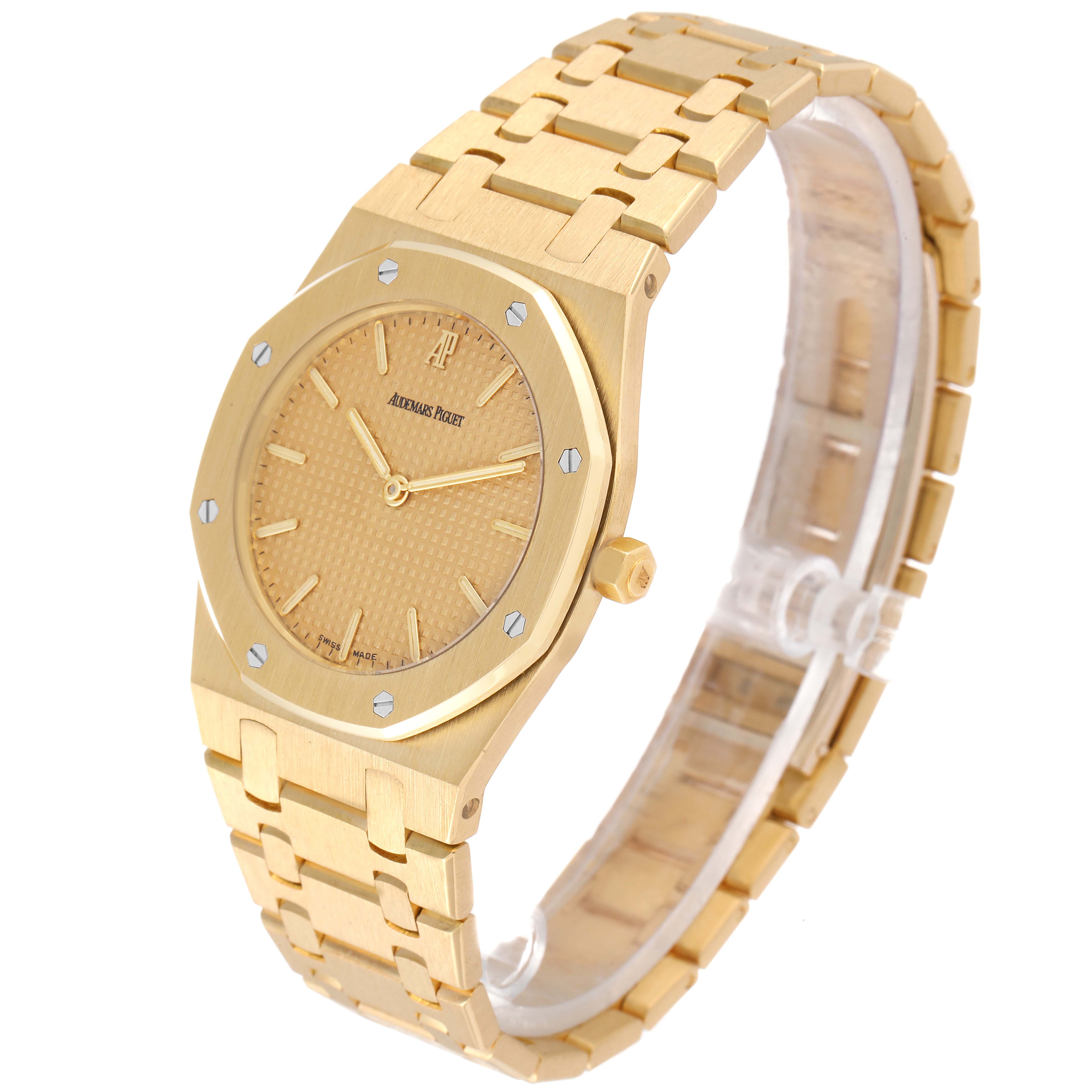 The image shows a side angle of the Audemars Piguet Royal Oak Men's Yellow Gold Champagne Dial Men's Yellow Gold Champagne Dial watch, featuring its gold-toned face, case, and bracelet.