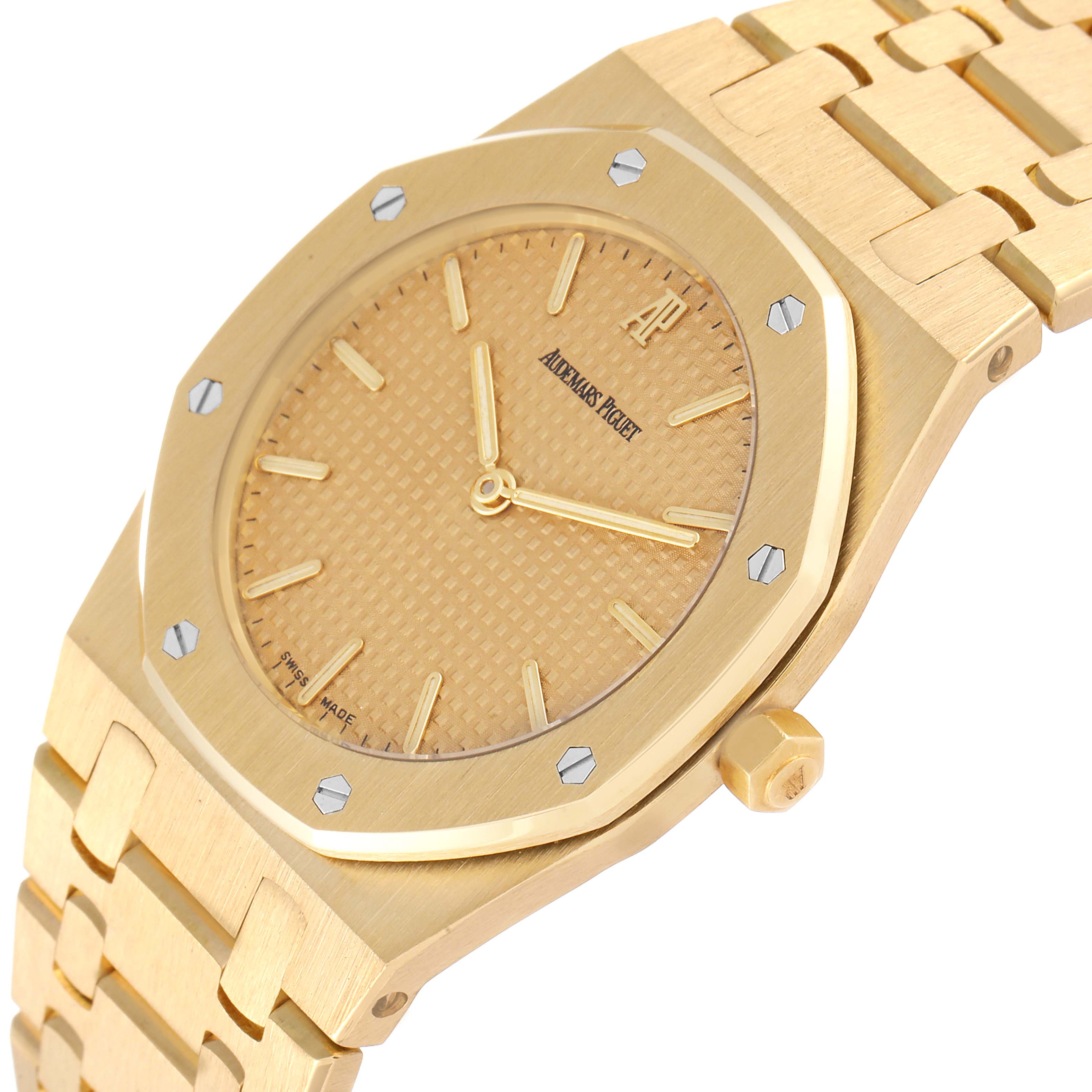 The image shows a close-up of the dial, case, bezel, crown, and bracelet of the Audemars Piguet Royal Oak Men's Yellow Gold Champagne Dial Men's Yellow Gold Champagne Dial watch.