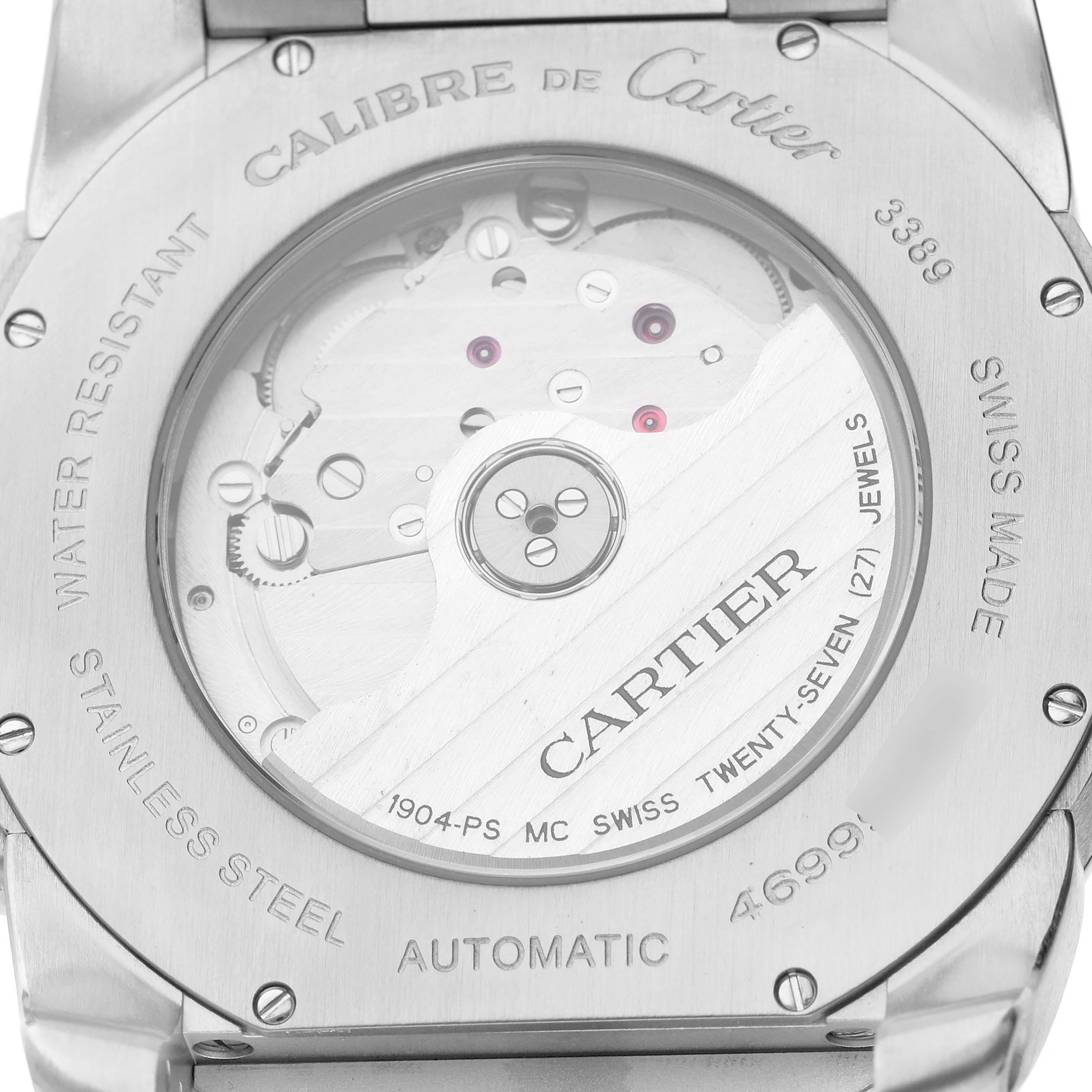 The image shows the back of a Calibre de Cartier watch, highlighting the automatic movement and engravings.