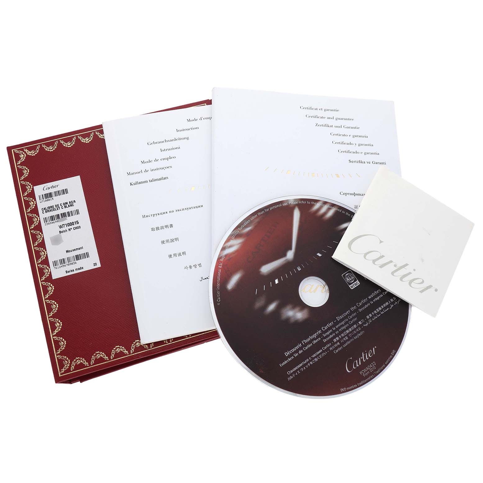 The image shows the accessories of a Calibre de Cartier watch, including a manual, warranty card, and a CD, all from Cartier.