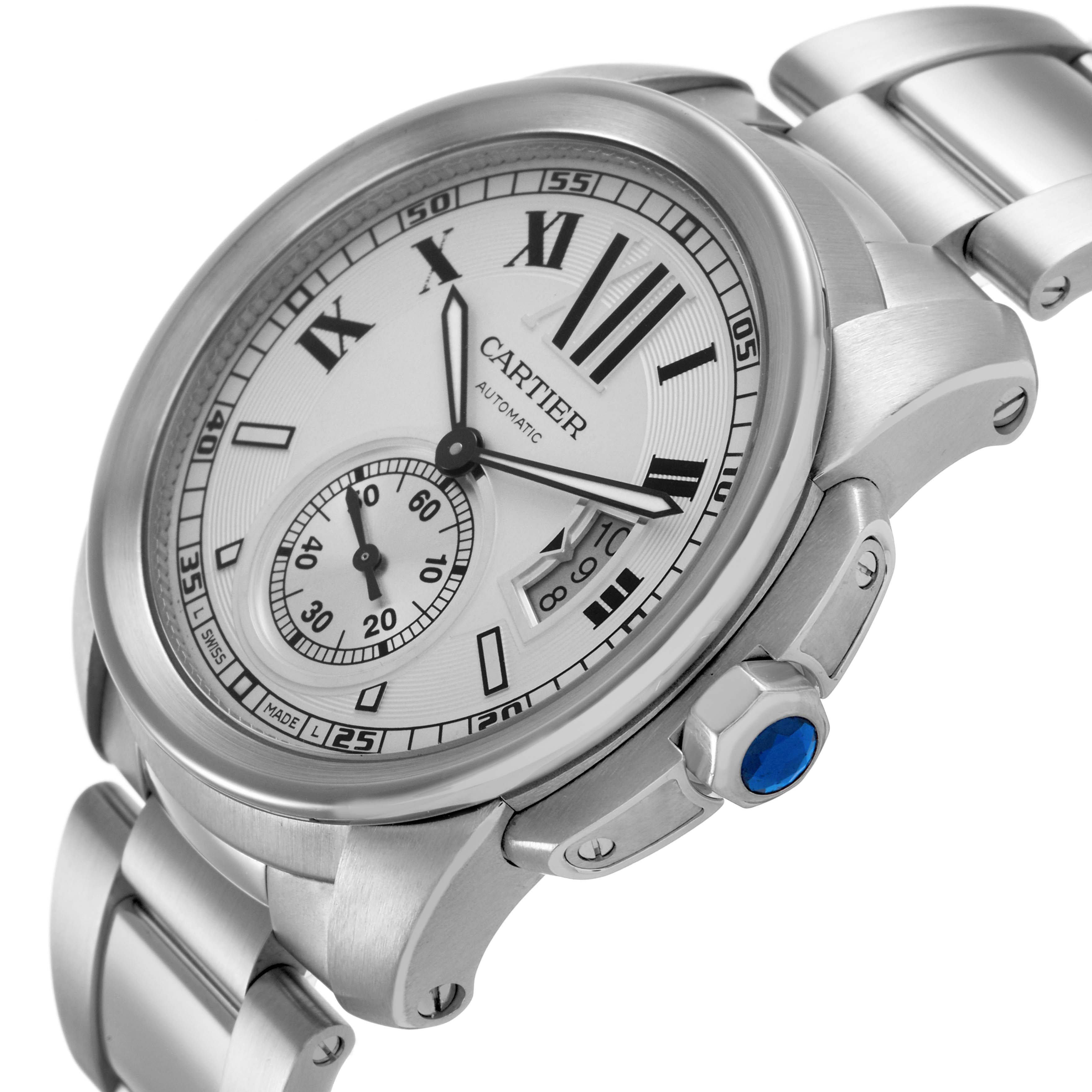 The Calibre de Cartier watch is shown at an angled side view, revealing the dial, bezel, crown with a blue gem, and part of the bracelet.