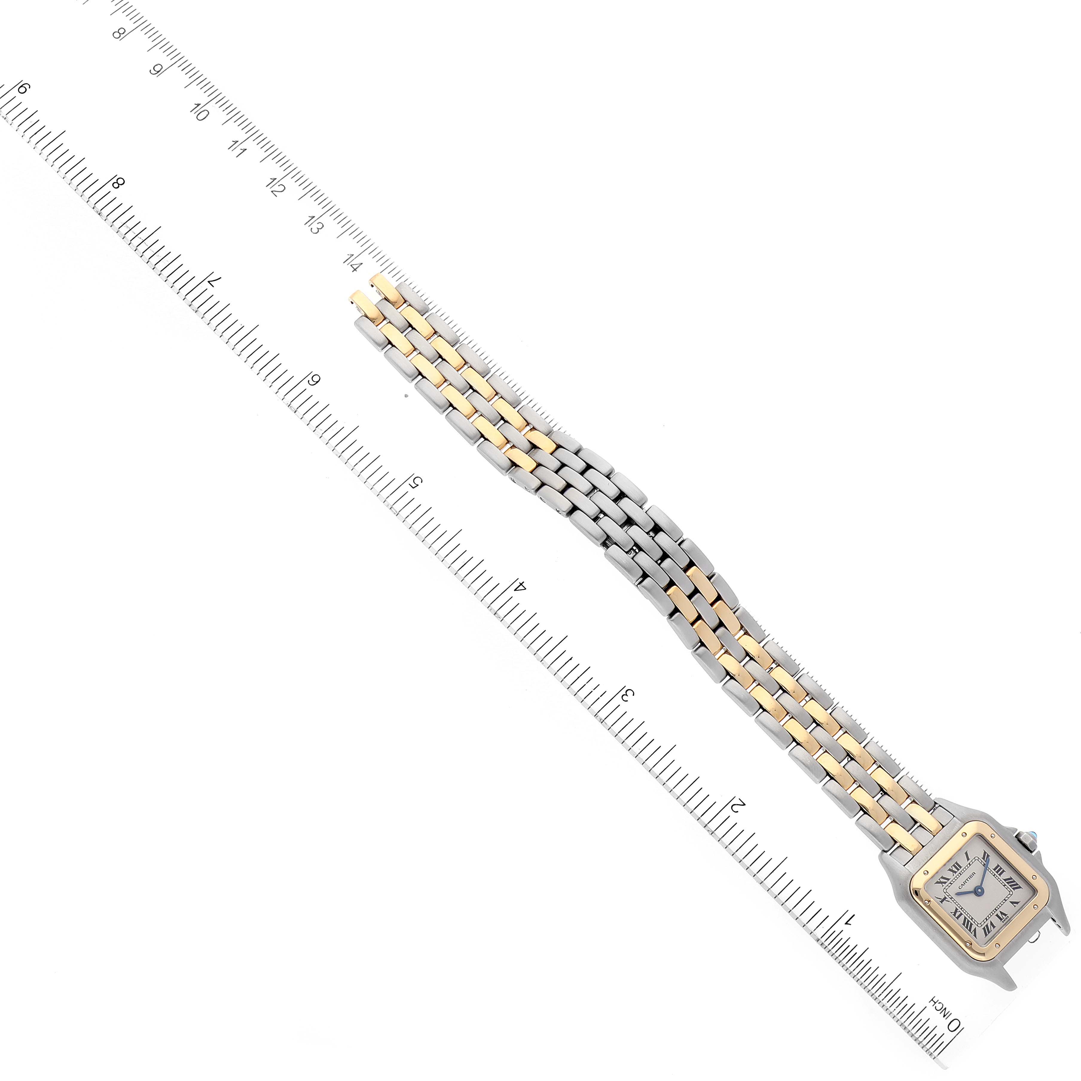 The image shows a Cartier Panthere W2502986 Women's Steel and Gold (two tone) Silver Dial W2502986 Women's Steel and Gold (two tone) Silver Dial watch from a top-down angle, featuring its two-tone bracelet and square face next to a ruler.