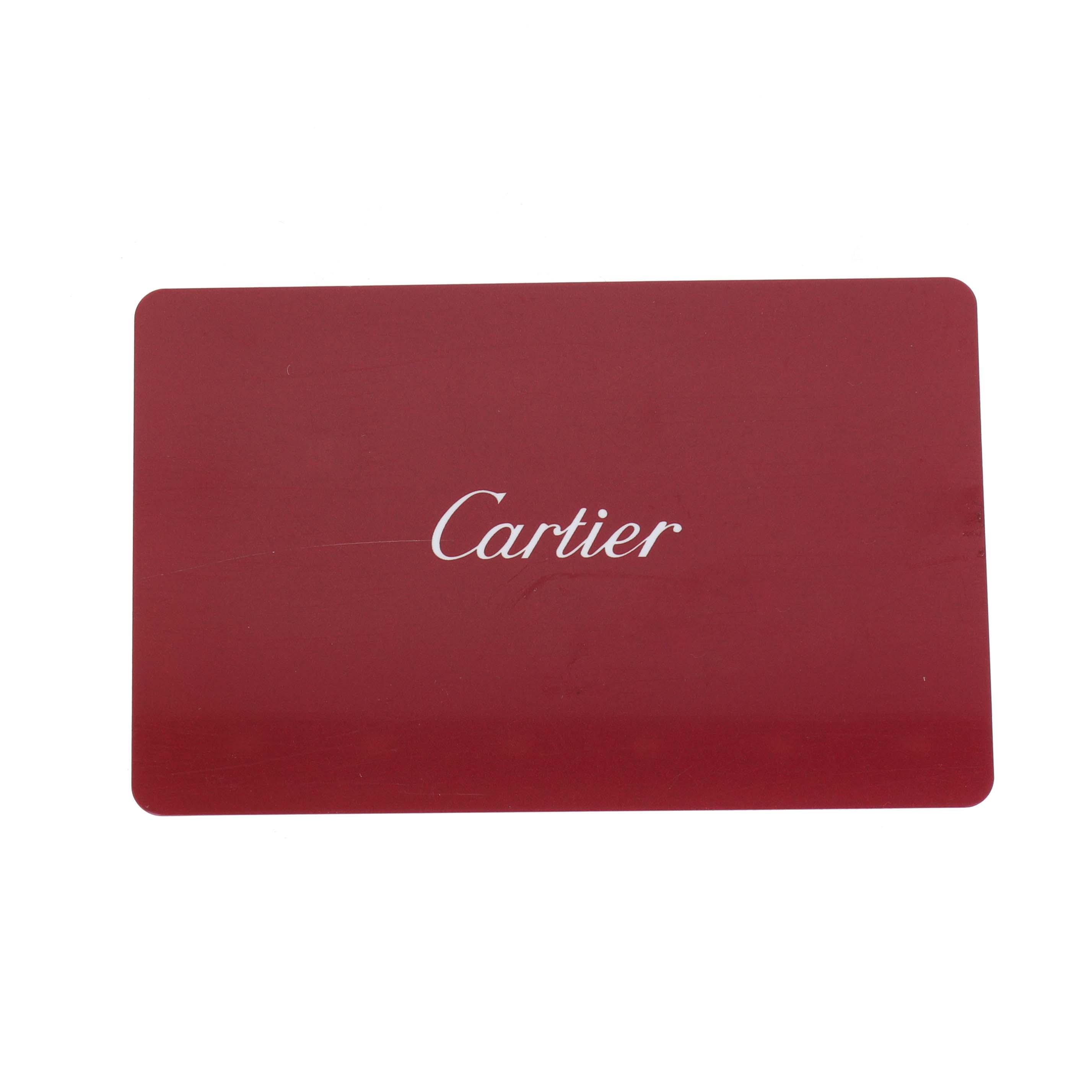The image shows a red accessory card with the Cartier logo, not the Roadster watch itself.