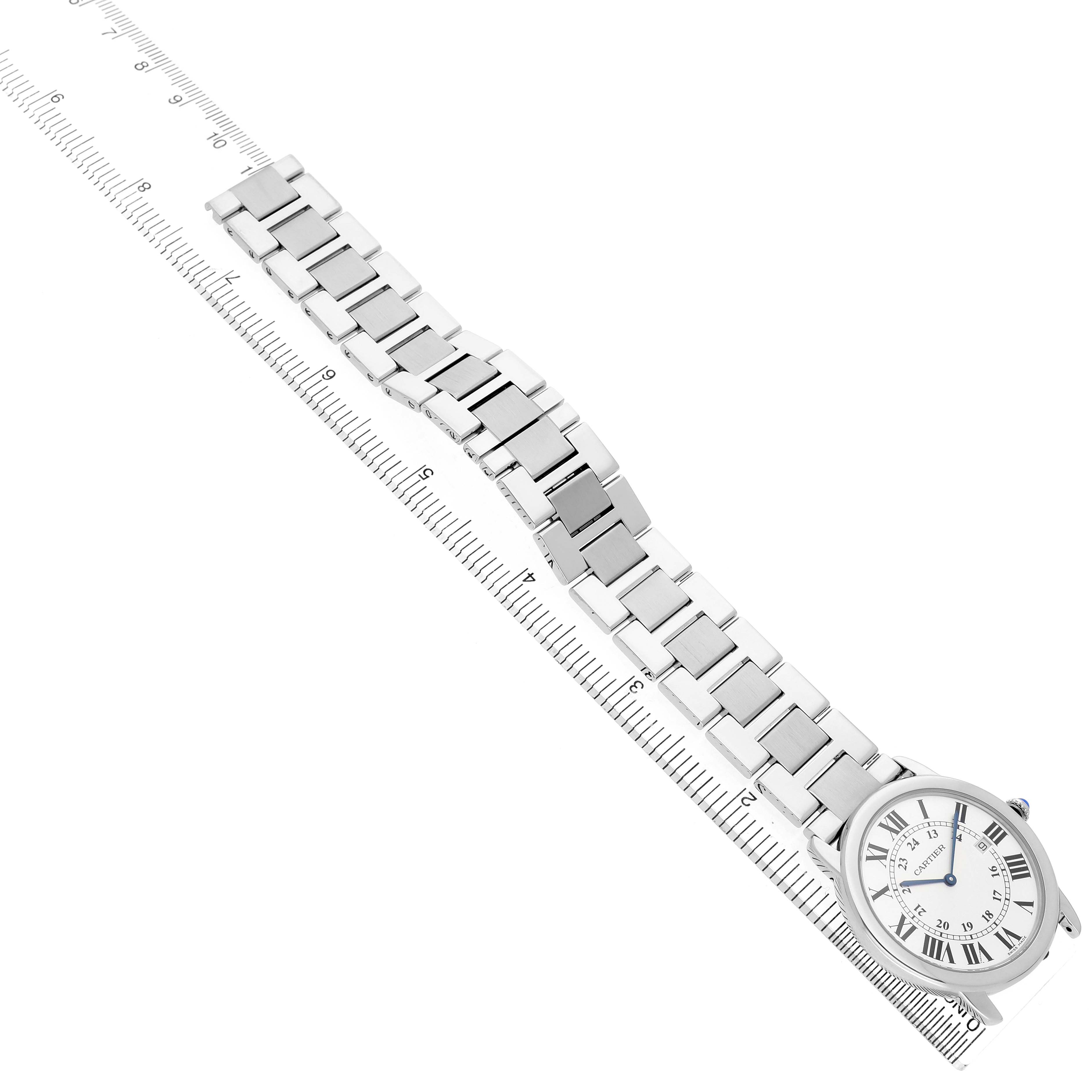 The image shows a Cartier Ronde W6701005 Men's Stainless Steel Silver Dial watch from an angled top view, highlighting the face, bracelet, and measurement with a ruler.