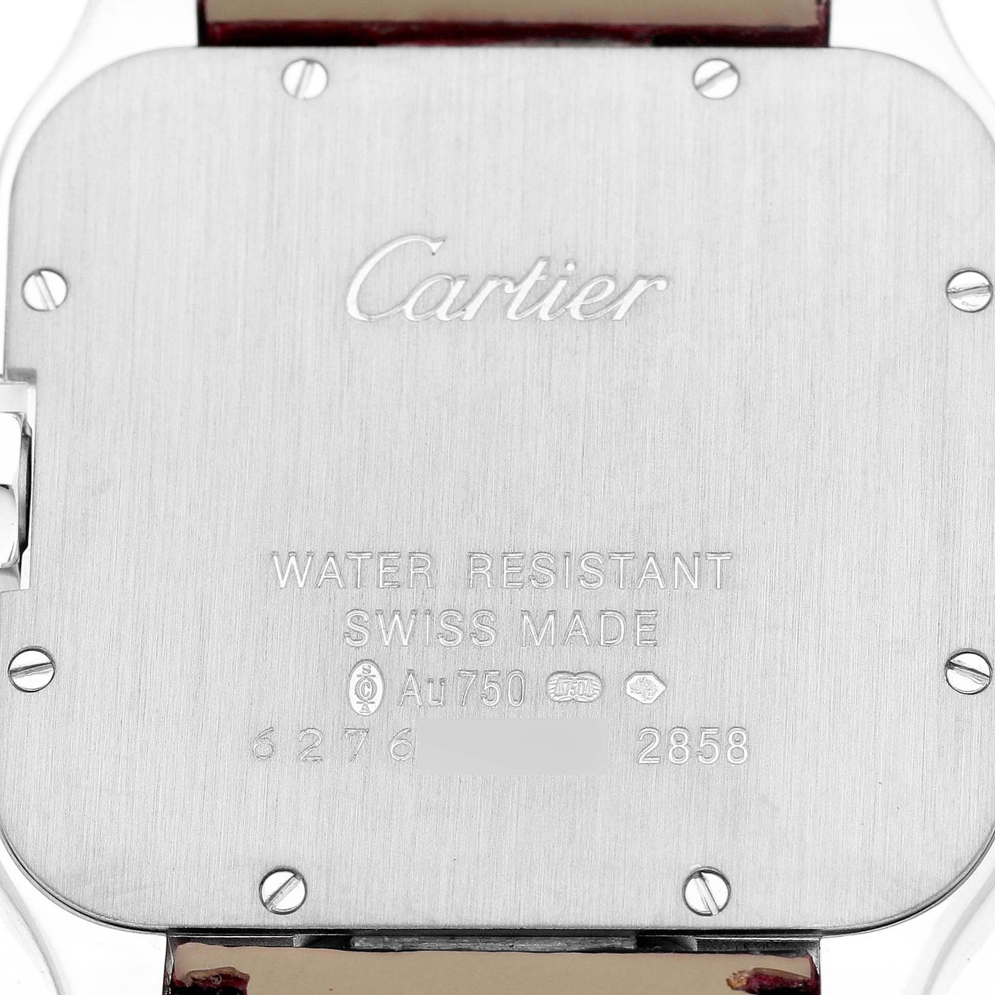 The image shows the back case of a Cartier Santos Dumont WH100251 Men's White Gold Silver Dial watch with engraved details and screws.