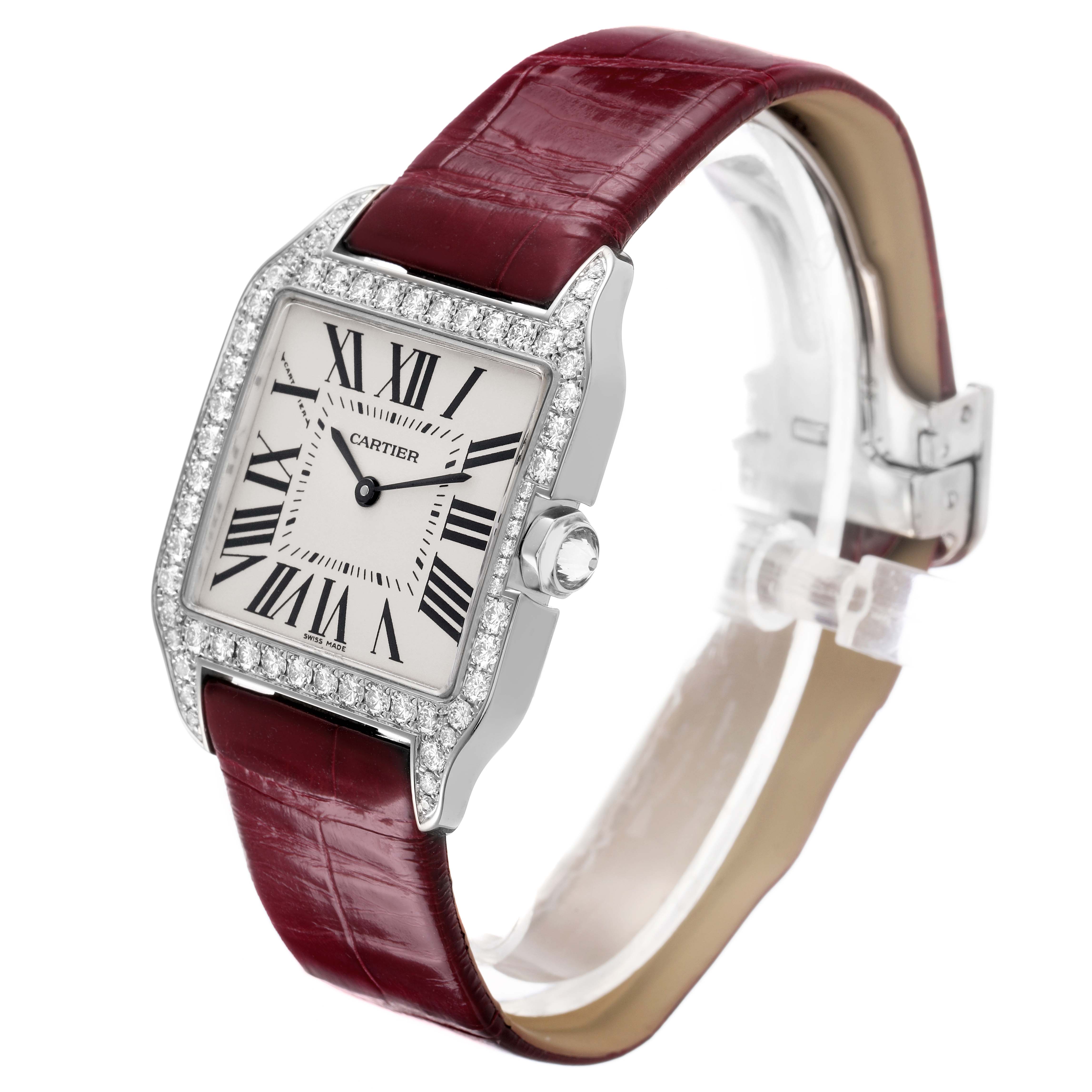 The Cartier Santos Dumont WH100251 Men's White Gold Silver Dial watch is shown at an angled side view, highlighting the face, bezel, crown, and burgundy strap.