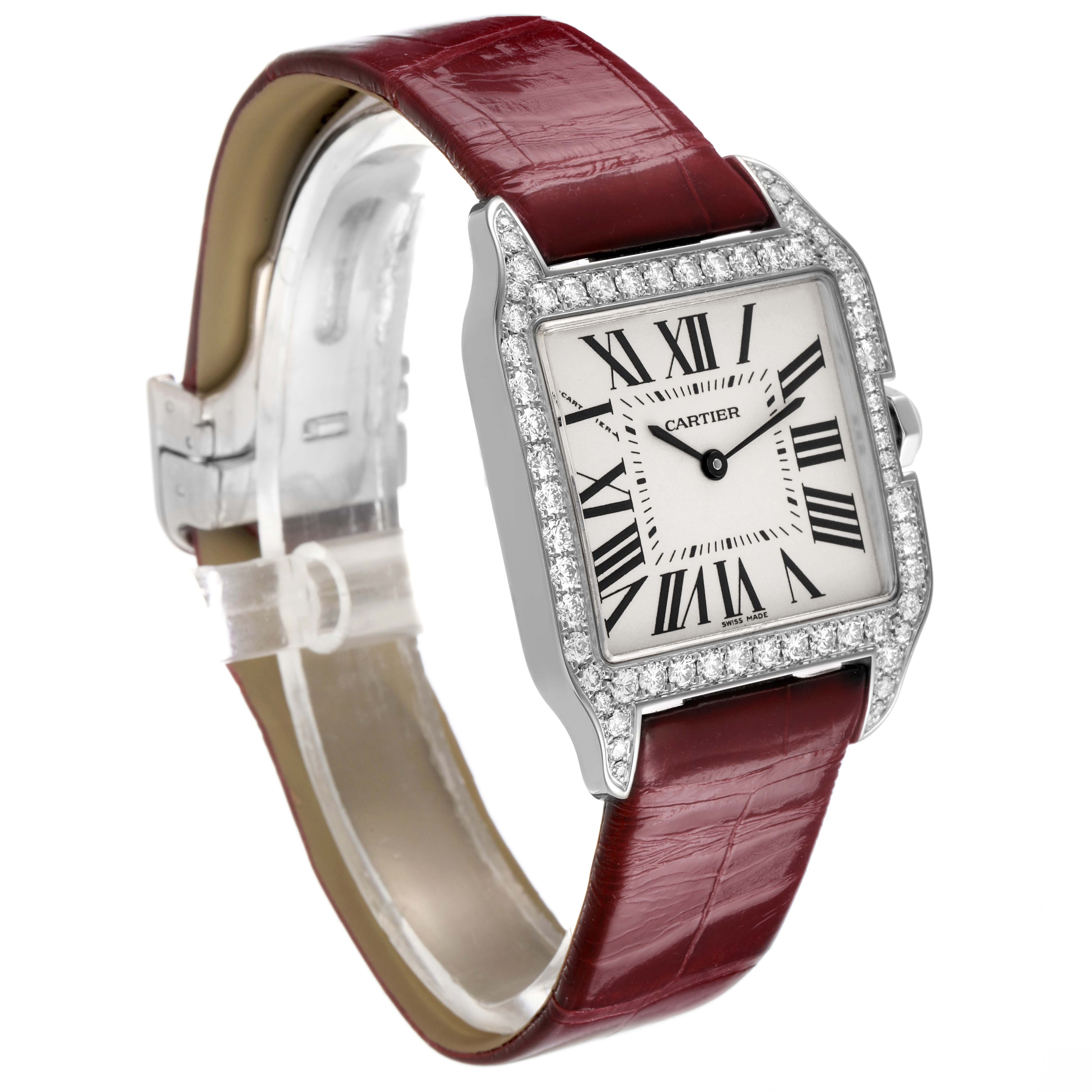 The Cartier Santos Dumont WH100251 Men's White Gold Silver Dial watch is shown at a three-quarter angle, highlighting the face, diamond bezel, and red leather strap.