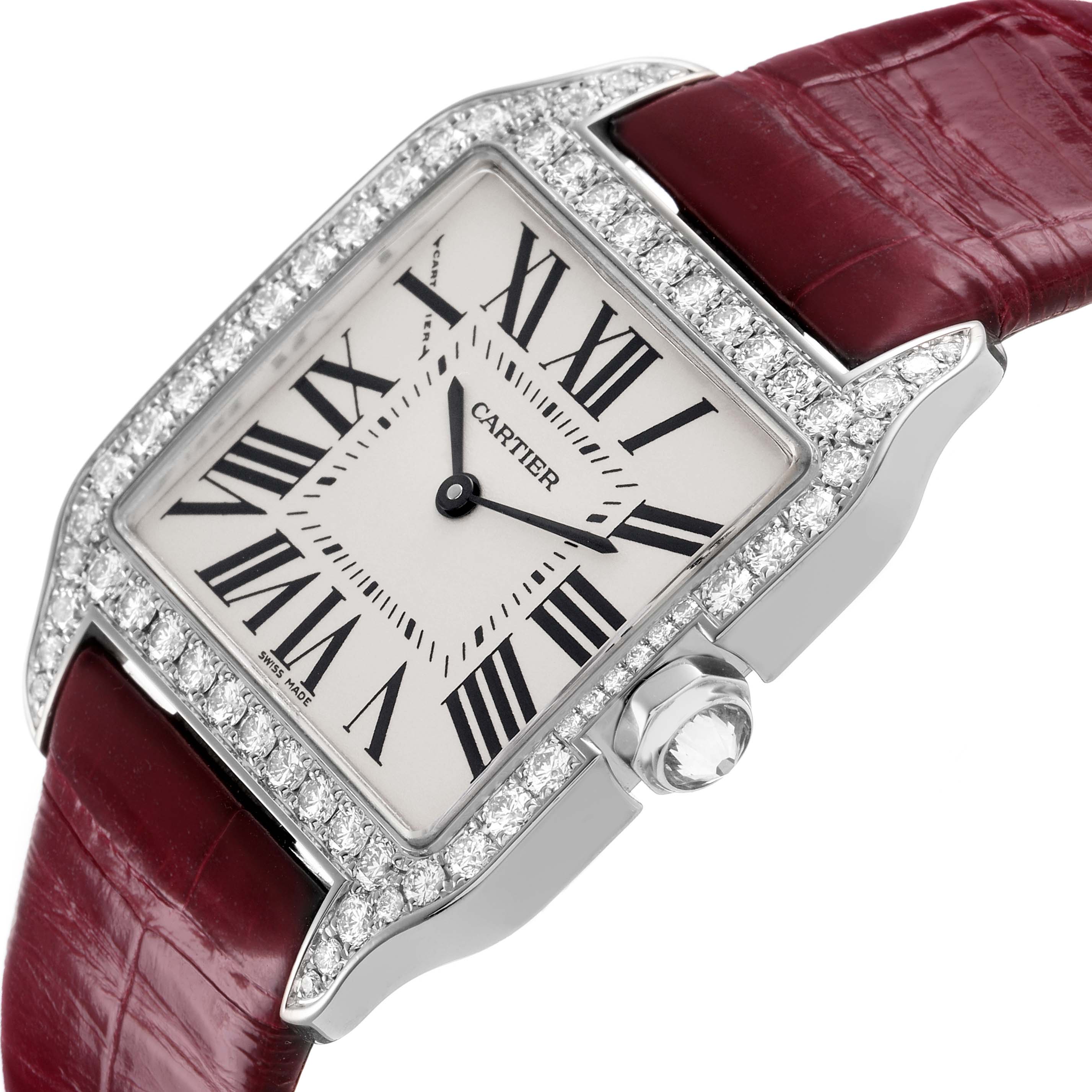 The Cartier Santos Dumont WH100251 Men's White Gold Silver Dial watch is shown at an angle highlighting its diamond-set bezel, white dial with Roman numerals, and red strap.