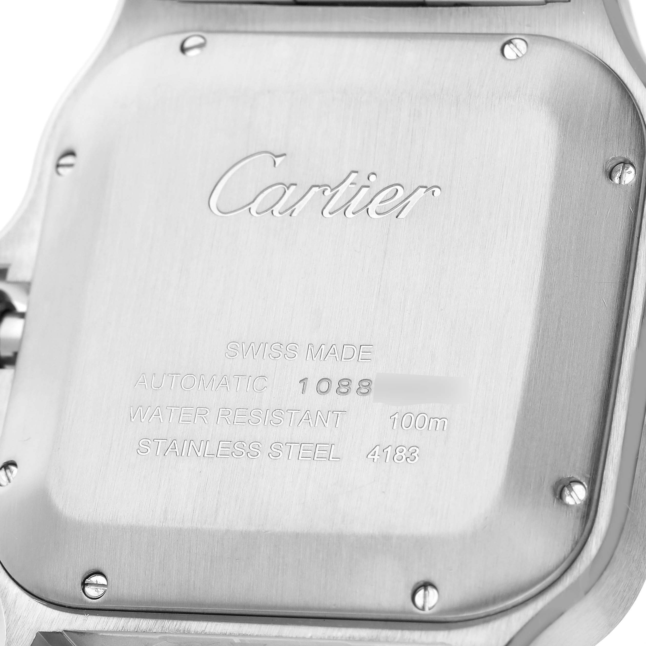The image shows the back case of a Cartier Santos W2SA0008 Men's Stainless Steel Silver Dial watch, highlighting its engraved details.