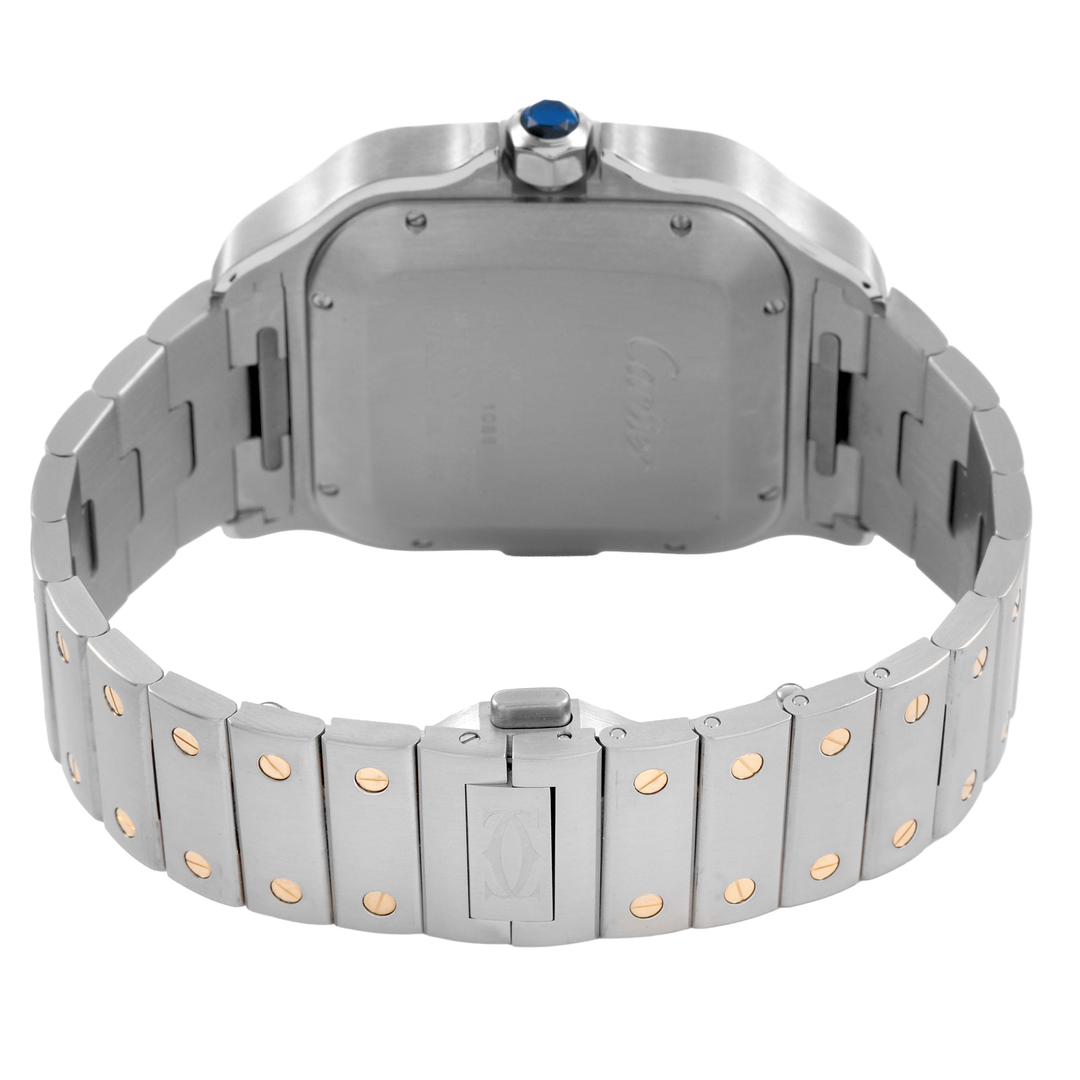 The image shows the back of the Cartier Santos W2SA0008 Men's Stainless Steel Silver Dial watch, highlighting the case back, bracelet, clasp, and crown with a blue gem.