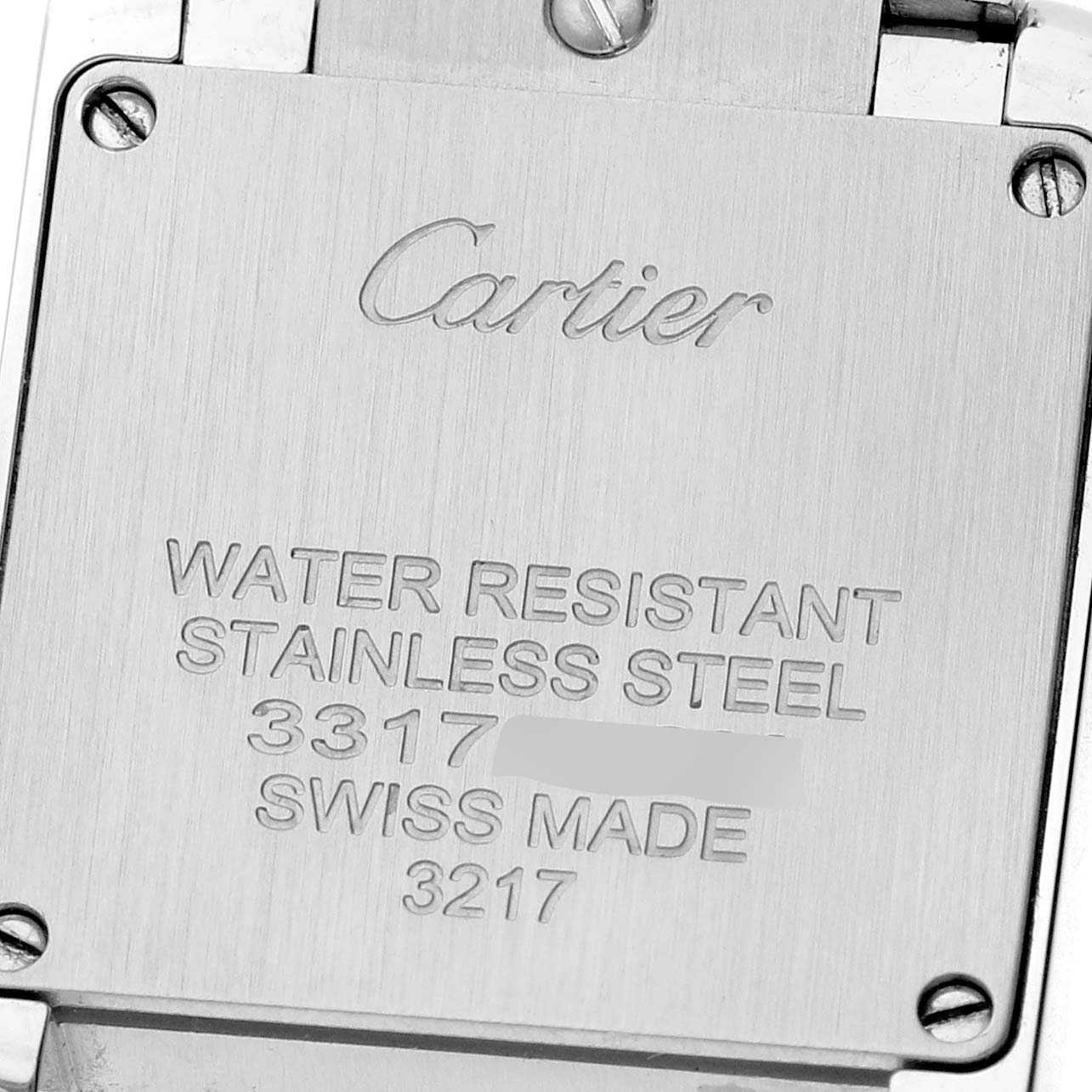 The image shows the back of a Cartier Tank Française watch, highlighting its engravings and screws.