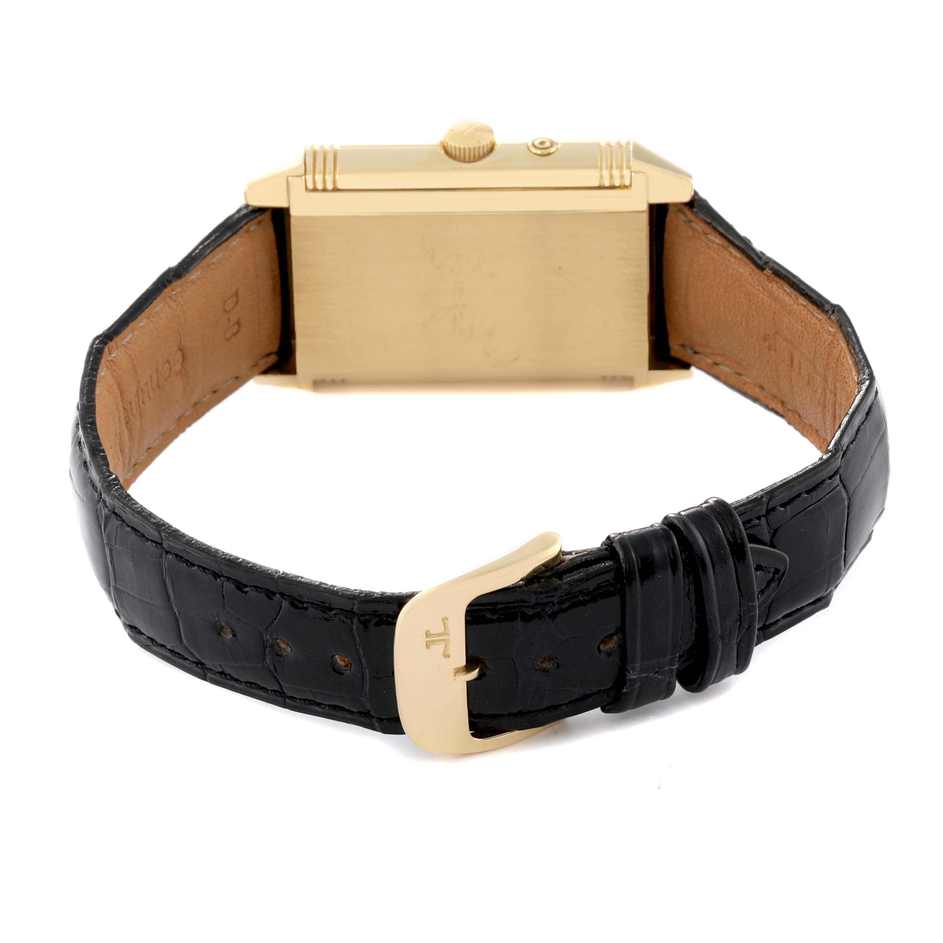 The image shows the back and side view of a Jaeger LeCoultre Reverso 270.1.54 Men's Yellow Gold Red Dial 270.1.54 Men's Yellow Gold Red Dial watch with a black leather strap and gold clasp.