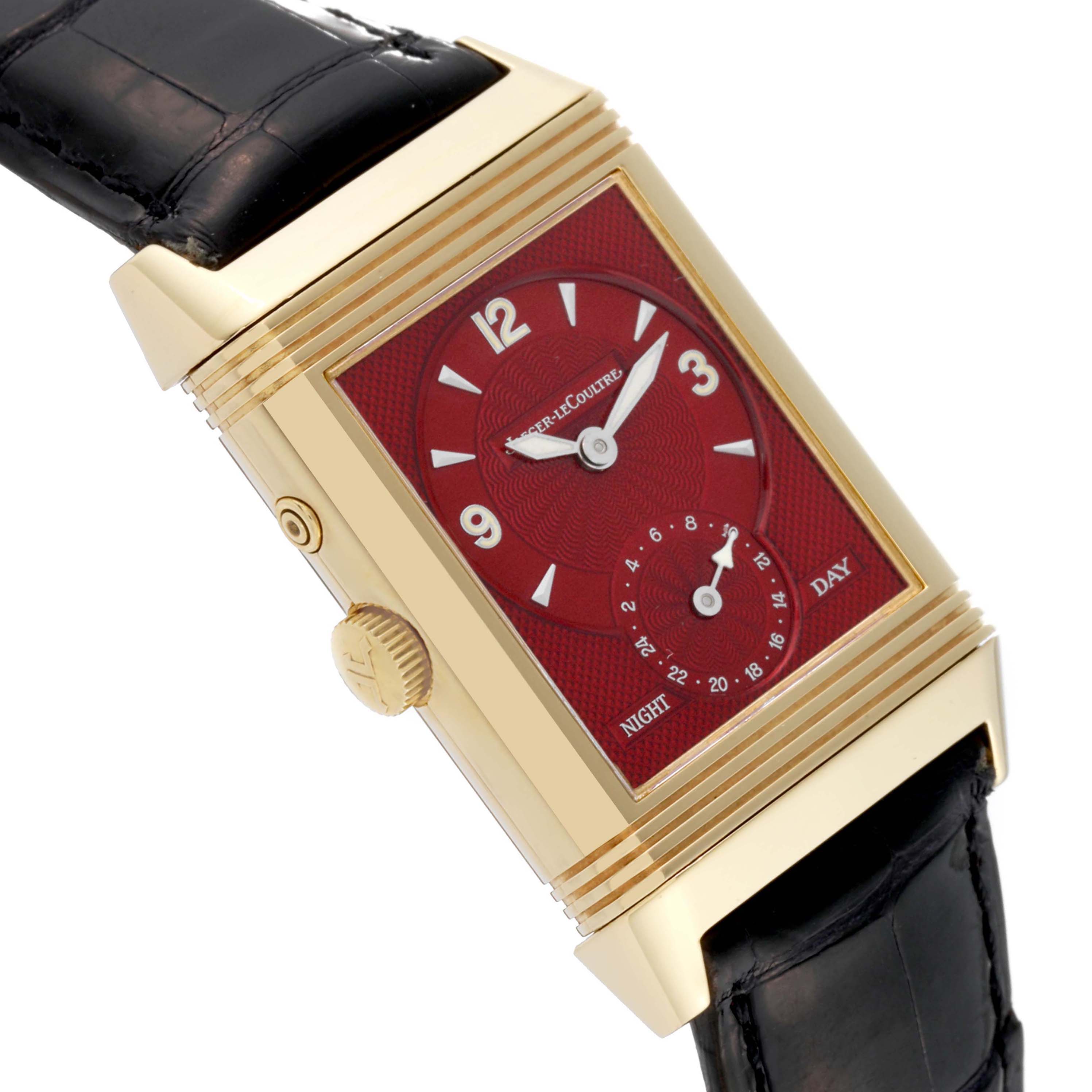 This image shows a close-up side view of the Jaeger-LeCoultre Reverso watch, highlighting its red dial and gold case.