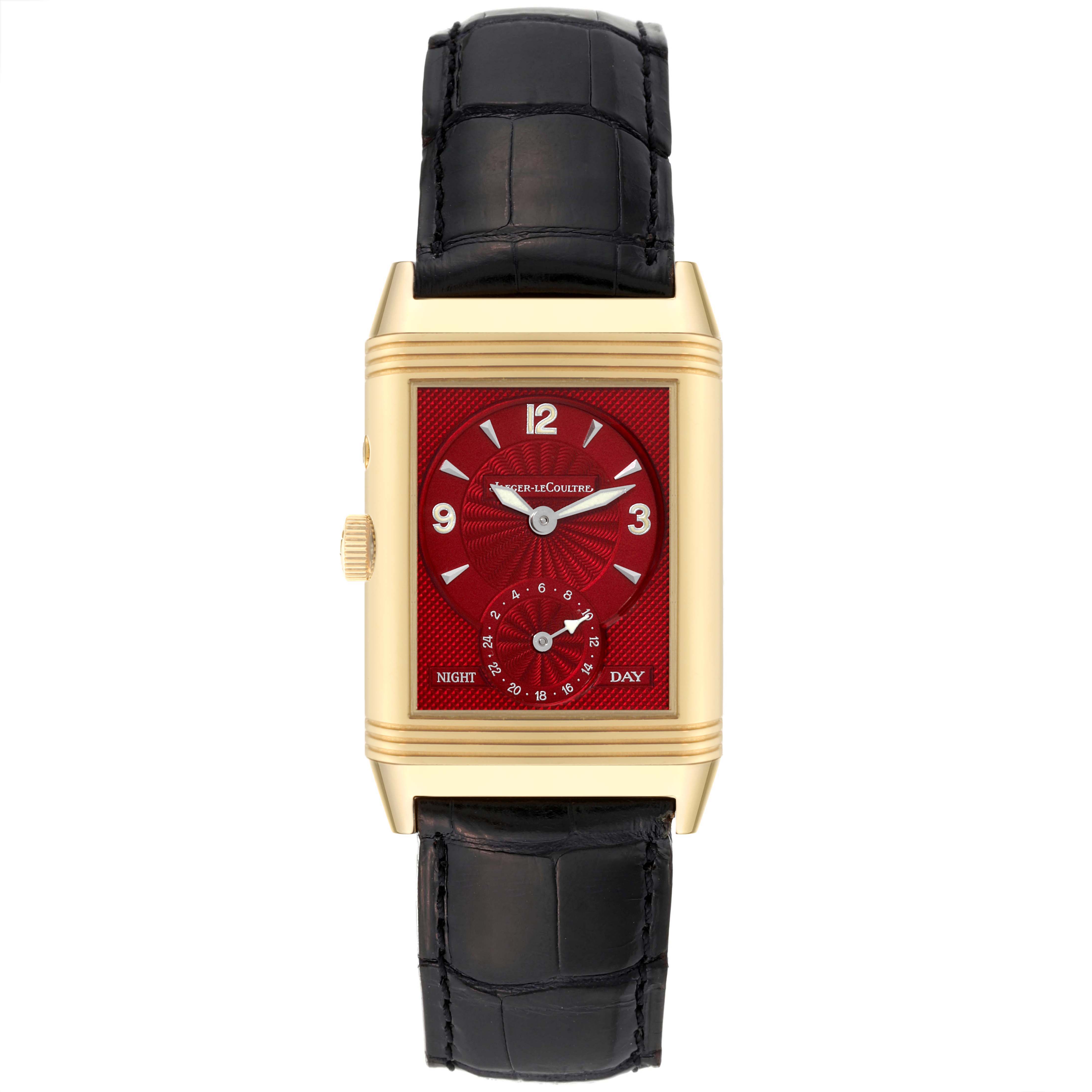 This Jaeger LeCoultre Reverso 270.1.54 Men's Yellow Gold Red Dial 270.1.54 Men's Yellow Gold Red Dial model watch is shown from a top view, displaying its rectangular red dial, gold casing, and black leather strap.