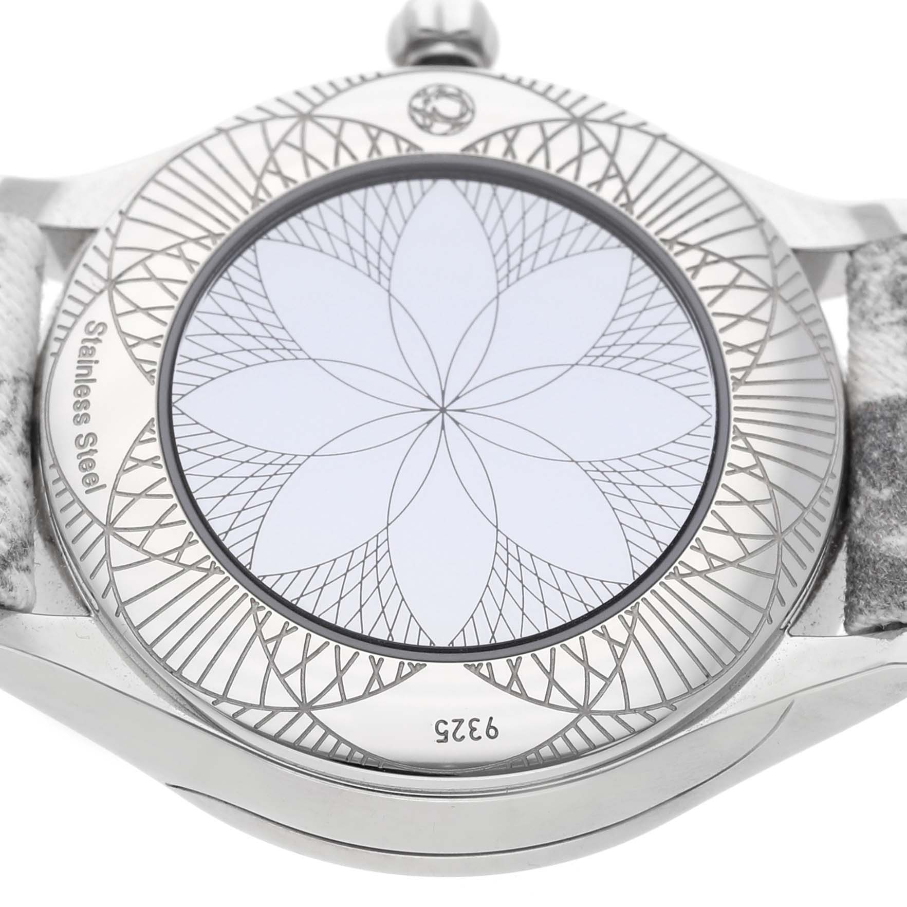 The image shows the back case of the Omega 428.17.26.60.04.002 Women's Stainless Steel White Dial DeVille Tresor Mini Butterfly Strap Steel Diamond Ladies Watch with an intricate floral design.