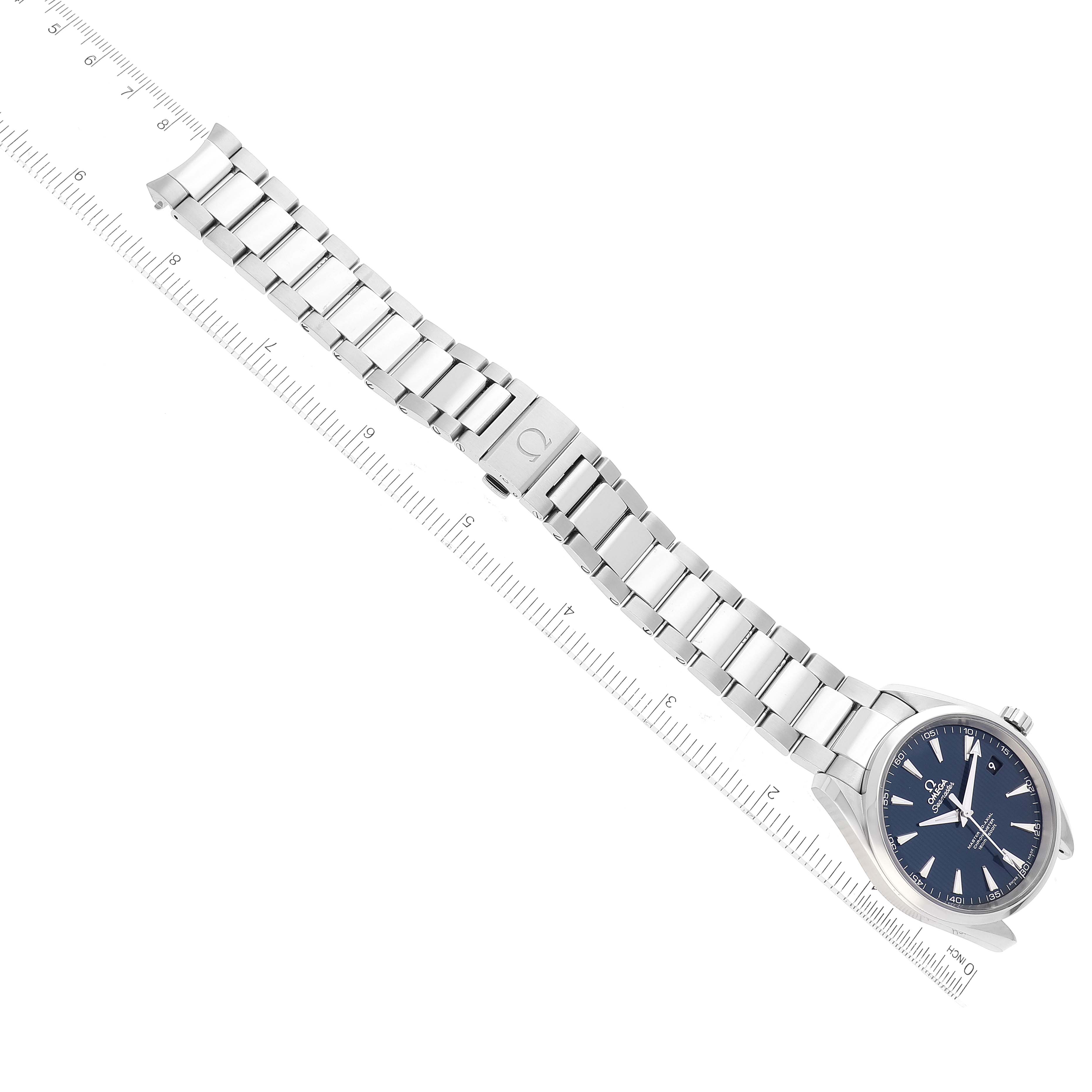 This image shows an Omega Aqua Terra 231.10.42.21.03.003 Men
s Stainless Steel Blue Dial 231.10.42.21.03.003 Men
s Stainless Steel Blue Dial watch laid flat, displaying its face, bezel, and metal bracelet against a ruler backdrop.