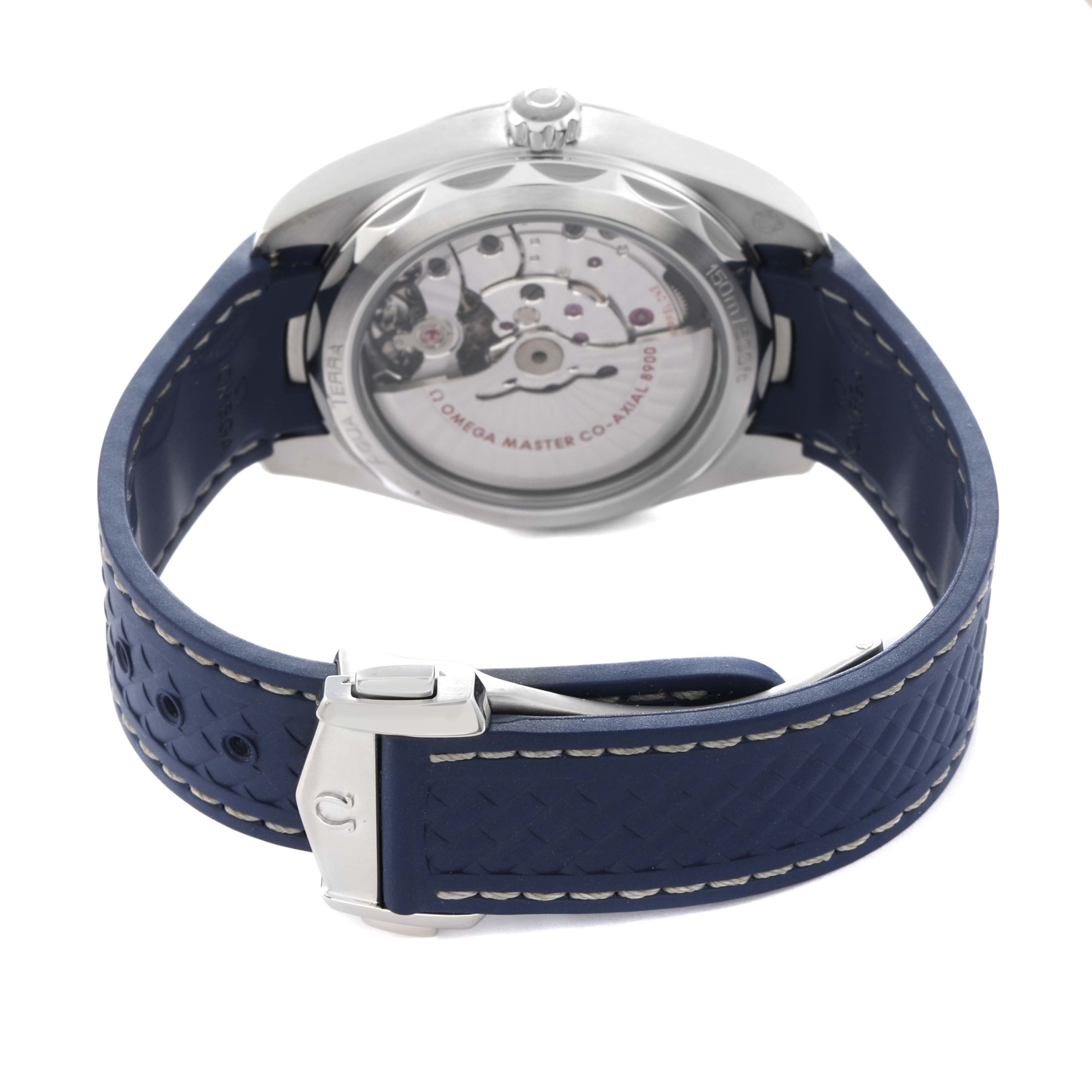 The Omega Aqua Terra 220.13.41.21.06.001 Men
s Stainless Steel Grey Dial 220.13.41.21.06.001 Men
s Stainless Steel Grey Dial watch is shown from the back, displaying the movement and featuring a blue strap with stitching and a clasp.