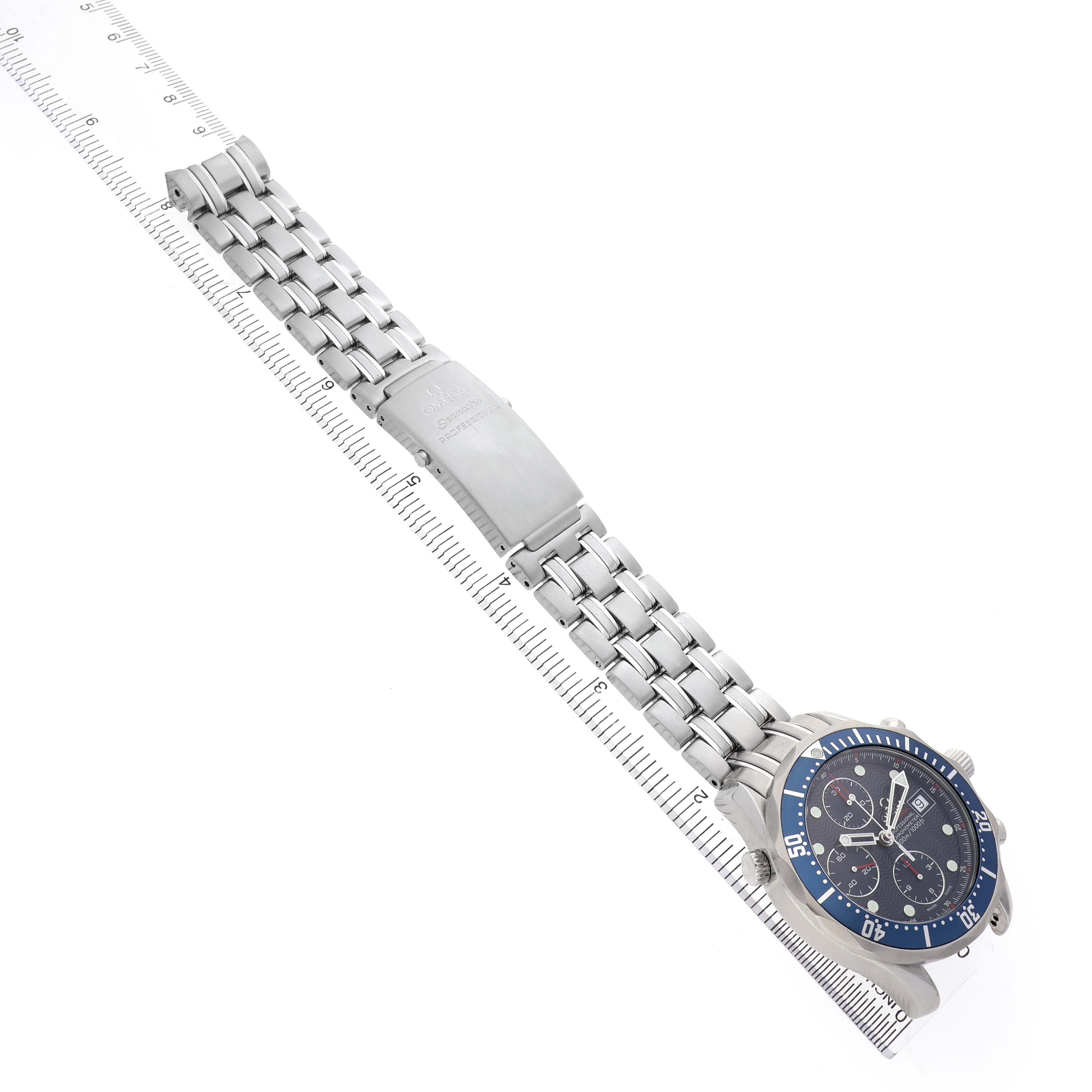 The Omega Seamaster 2225.80.00 Men's Stainless Steel Blue Dial is shown from an angled top view, highlighting the face, bezel, bracelet, and clasp alongside a ruler.